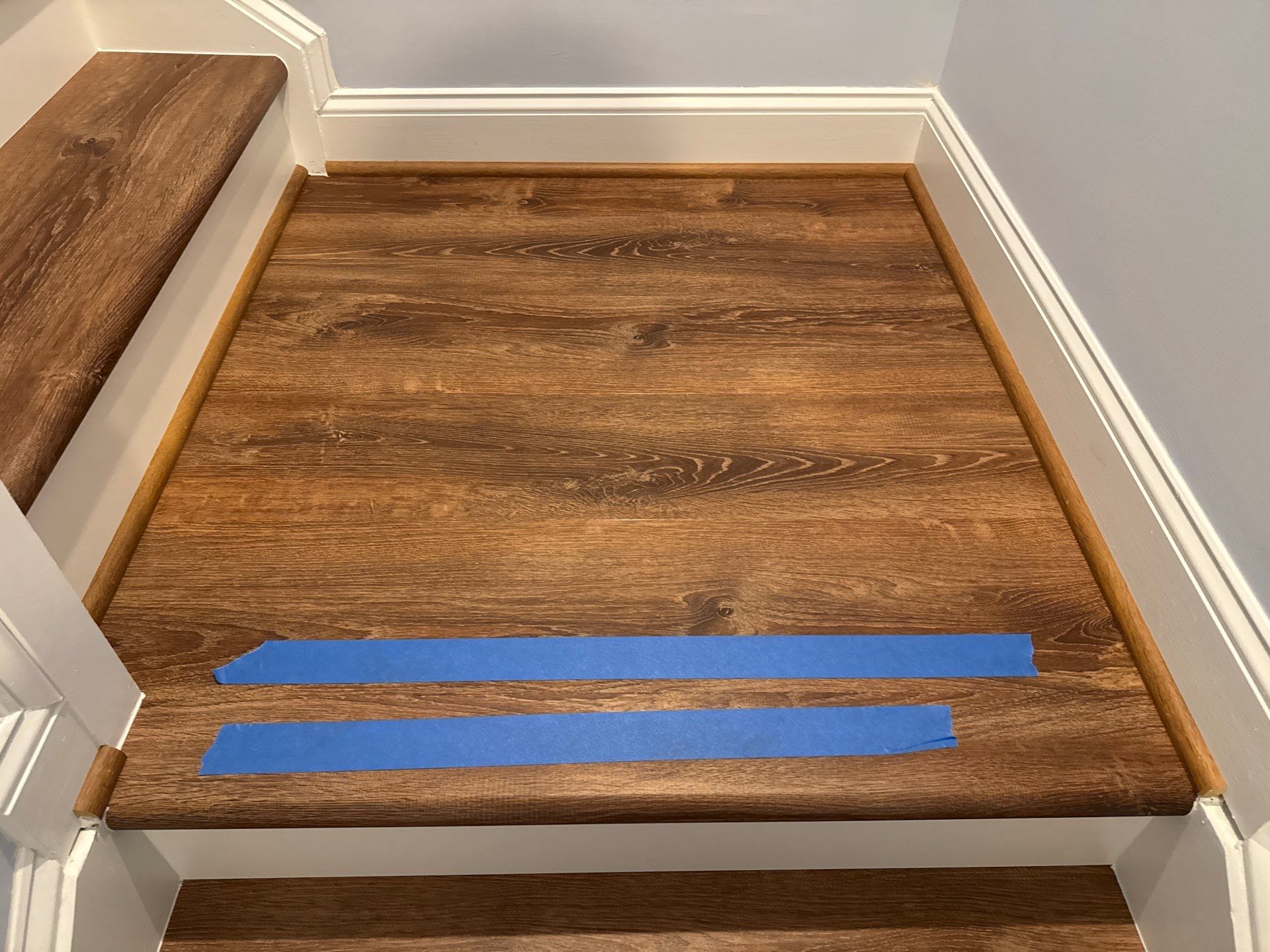 Stairway Installation using t vinyl stair tread and reversibleriser by La Bendicion Contruction Llc