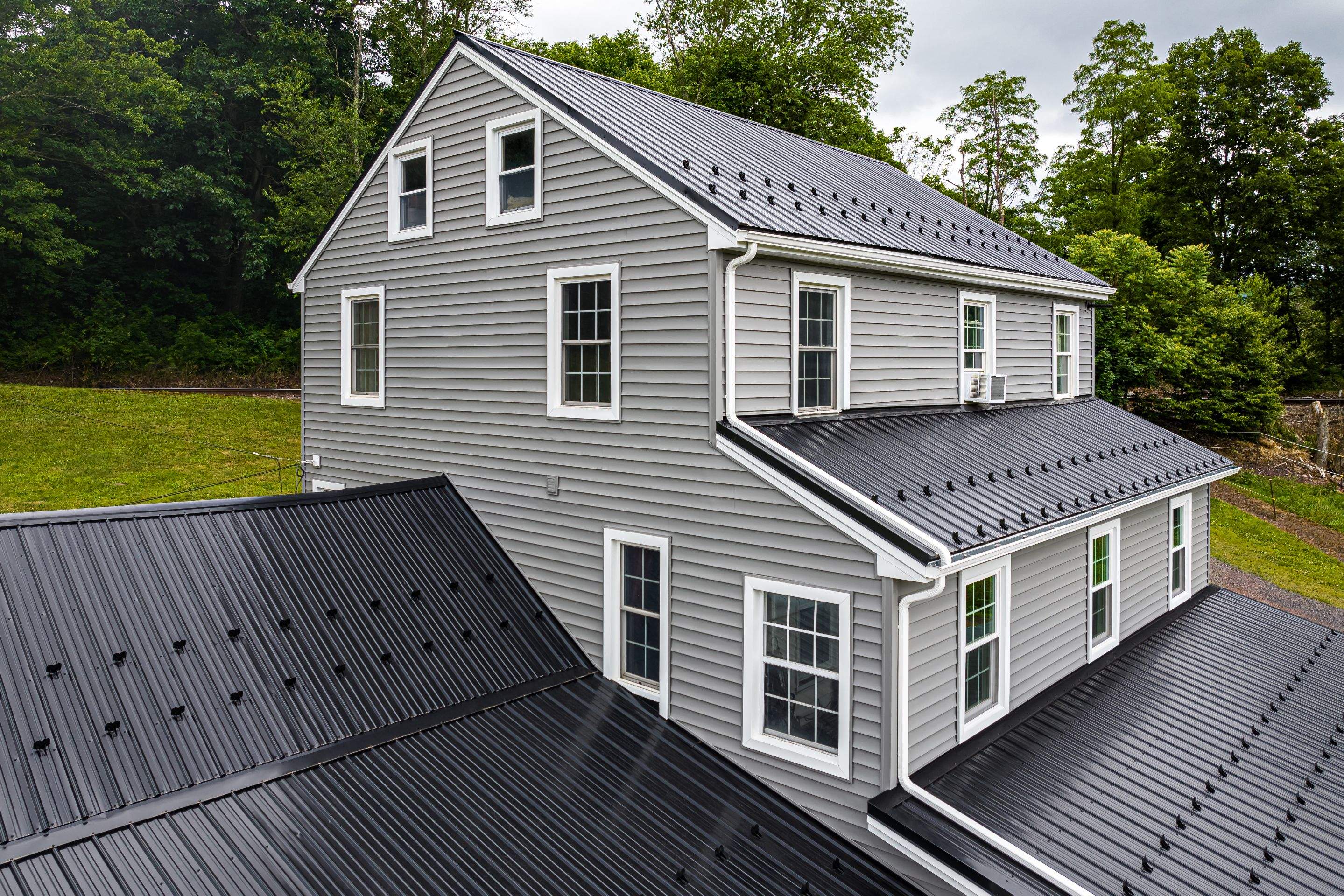 New Metal roof and New siding by Esh Builders