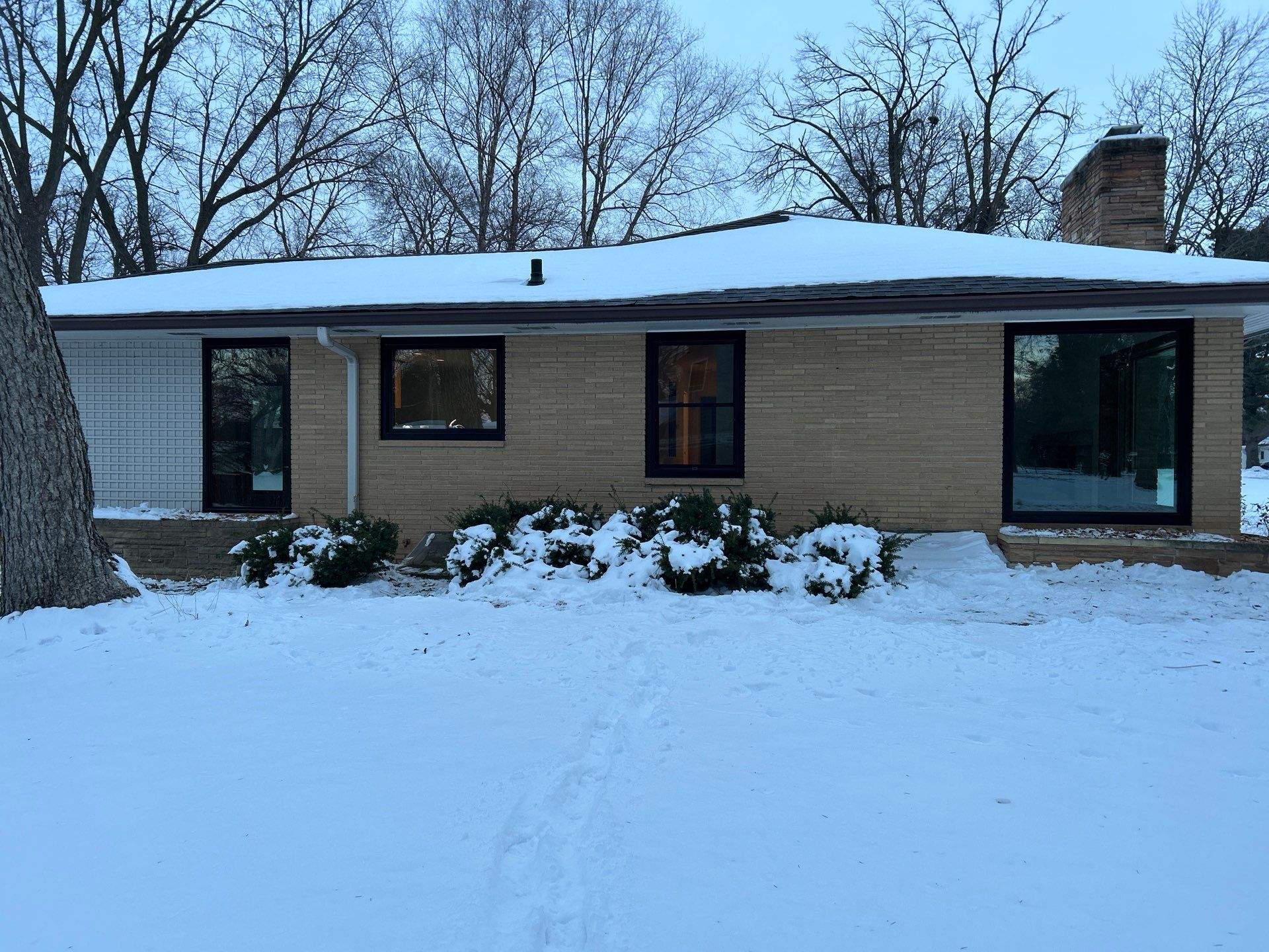 Black-Frame Pella Lifestyle Upgrade on a Partial Brick Home by United Windows and Siding LLC