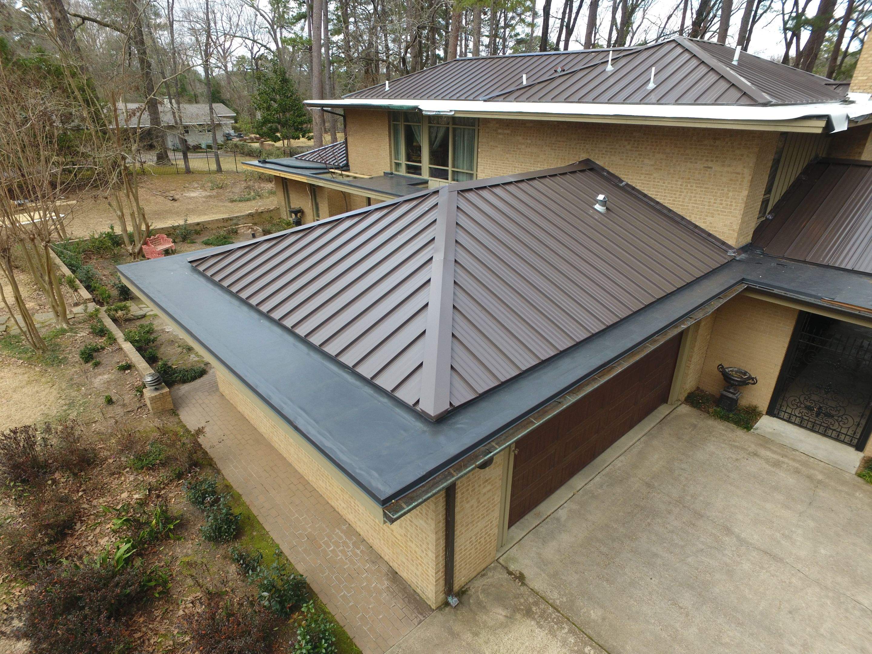 Residential Roofing Installation using PVC membrane and 24 gauge Standing Seam Metal by Hostetler Roofing