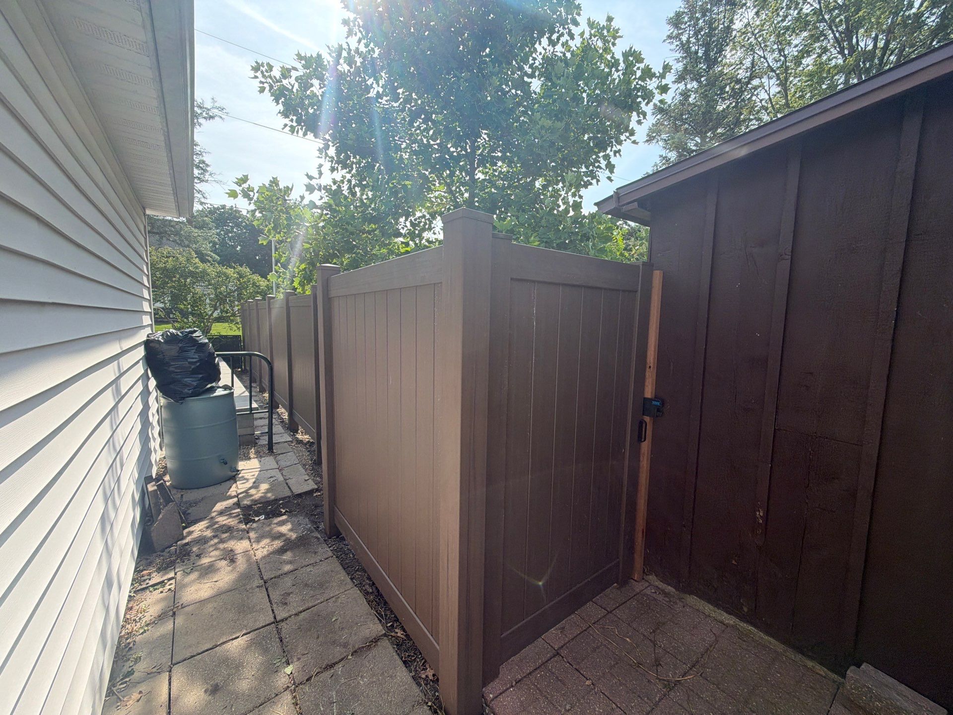 Walnut Vinyl Privacy Fence Installation in Waterloo by Perfect Picket Fence and Stain