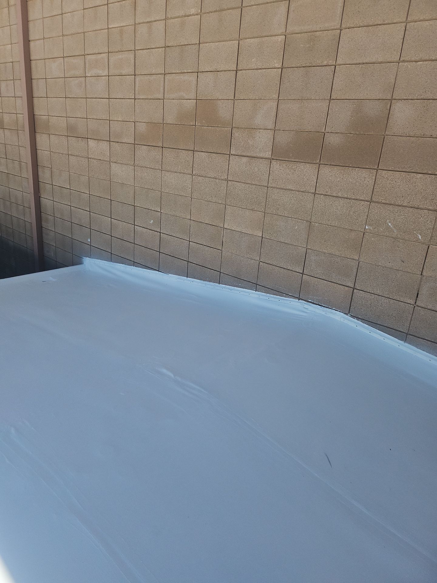 Single-ply restoration system using Benchmark/PUMA XL coatings over TPO single-ply roofing by Straight Edge Roofing Inc