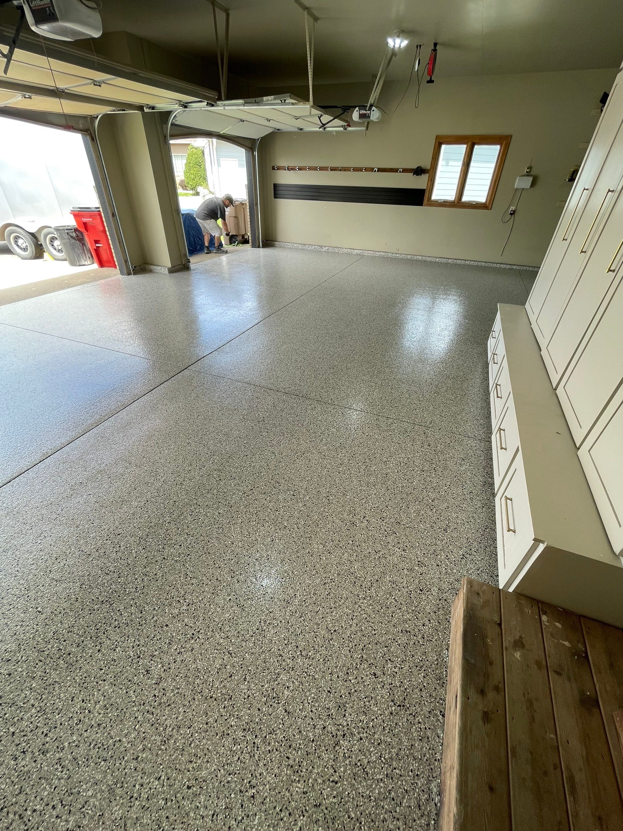 Cabin FEver Flake Garage Floor Coating Installation in Sioux Falls by Select Painting, Coatings & Garage Cabinets