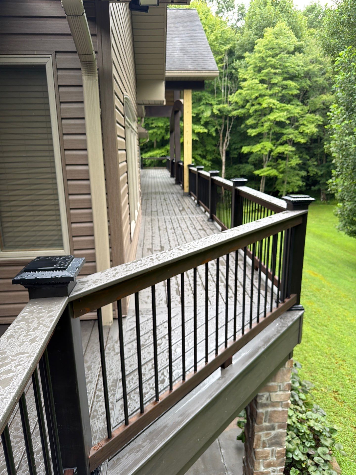 Custom Composite Deck Construction with Stone Pillars in Fayetteville by Walnut Hollow Decks & Outdoor Living