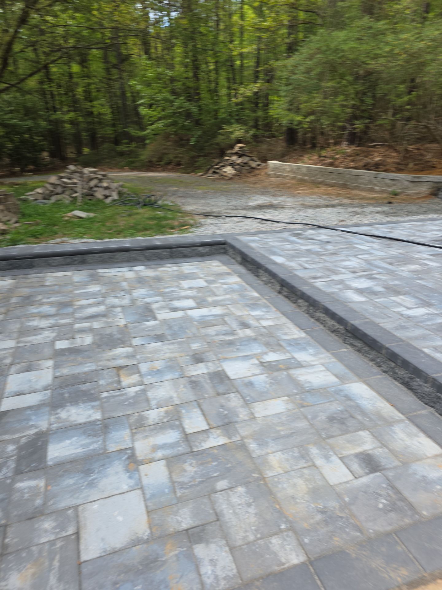 Pittsboro Outdoor Living Transformation – Retaining Wall, Paver Patio & Elevated Deck by Elite Remodeling and Design LLC