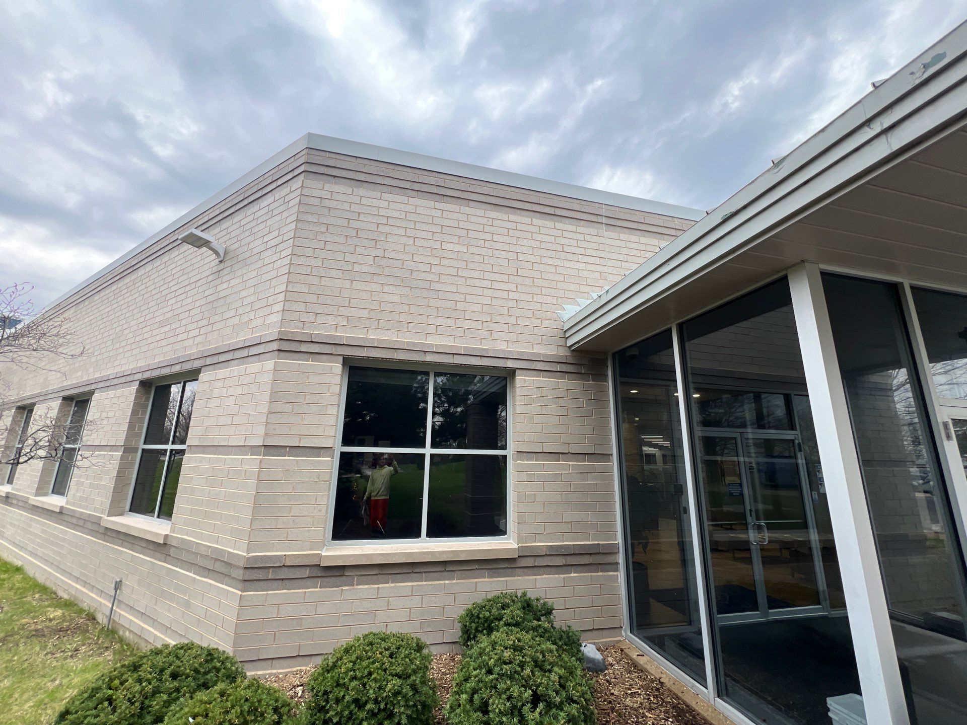 Commercial Facade cleaning using Algaecide, soft wash soap by Northern Power Washing LLC.