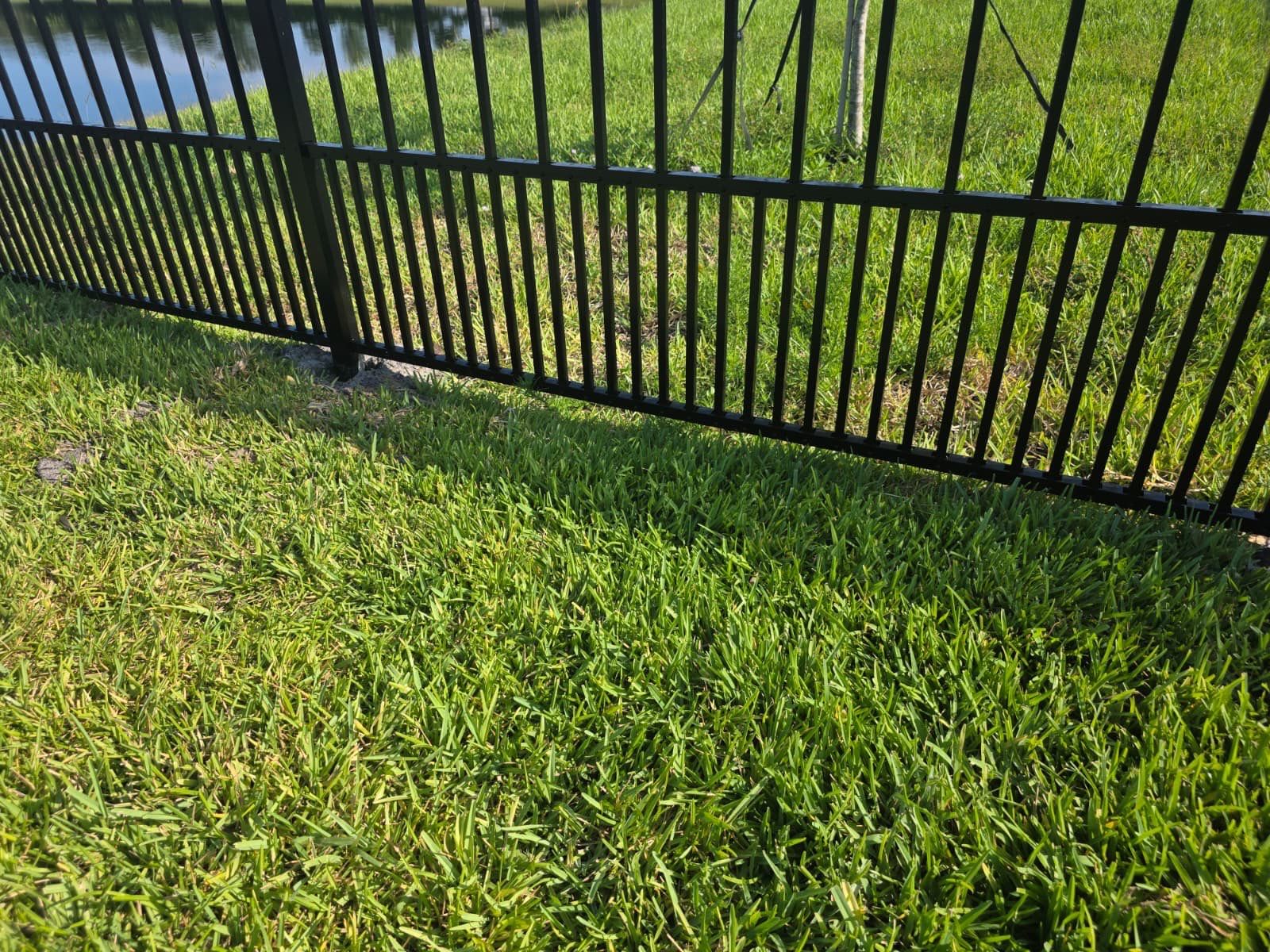 Black Aluminum Puppy Picket Fence Installation in Nokomis by True Fence LLC