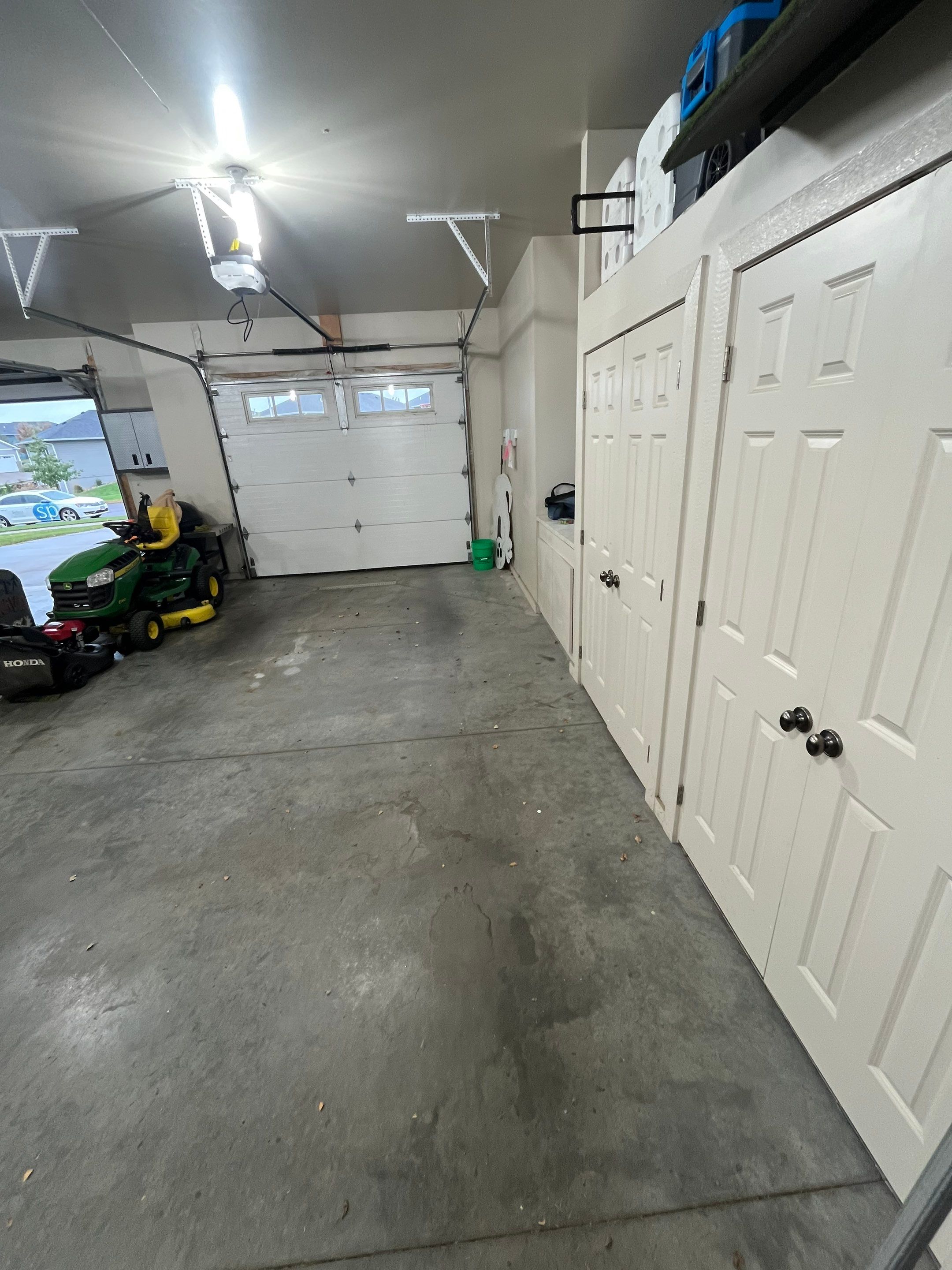 Coyote Flake Garage Floor Coating in Sioux Falls with Trench Drain by Select Painting, Coatings & Garage Cabinets