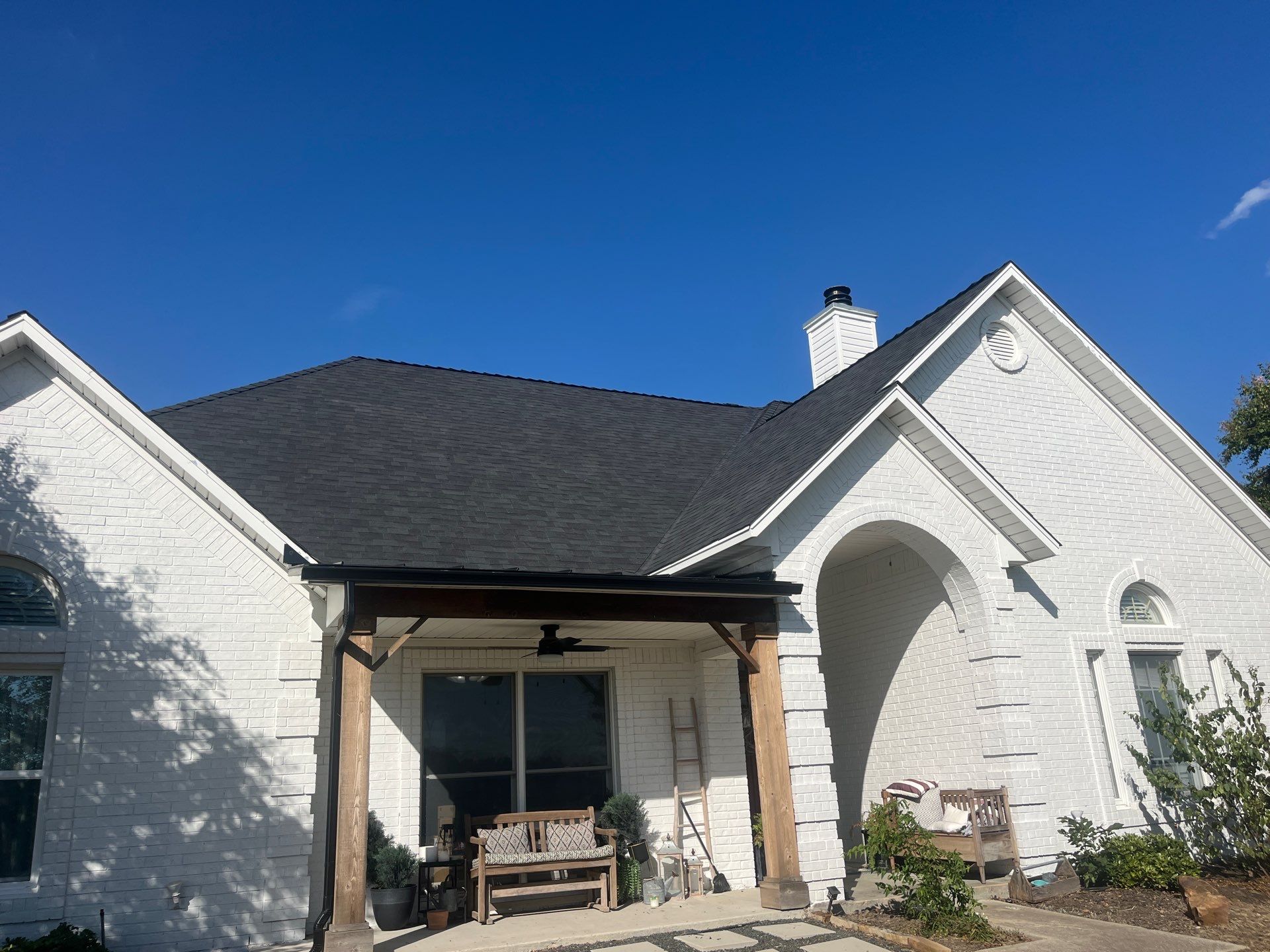 White brick with Malarkey Brilliant Black by Tejas Roofworks + Restoration