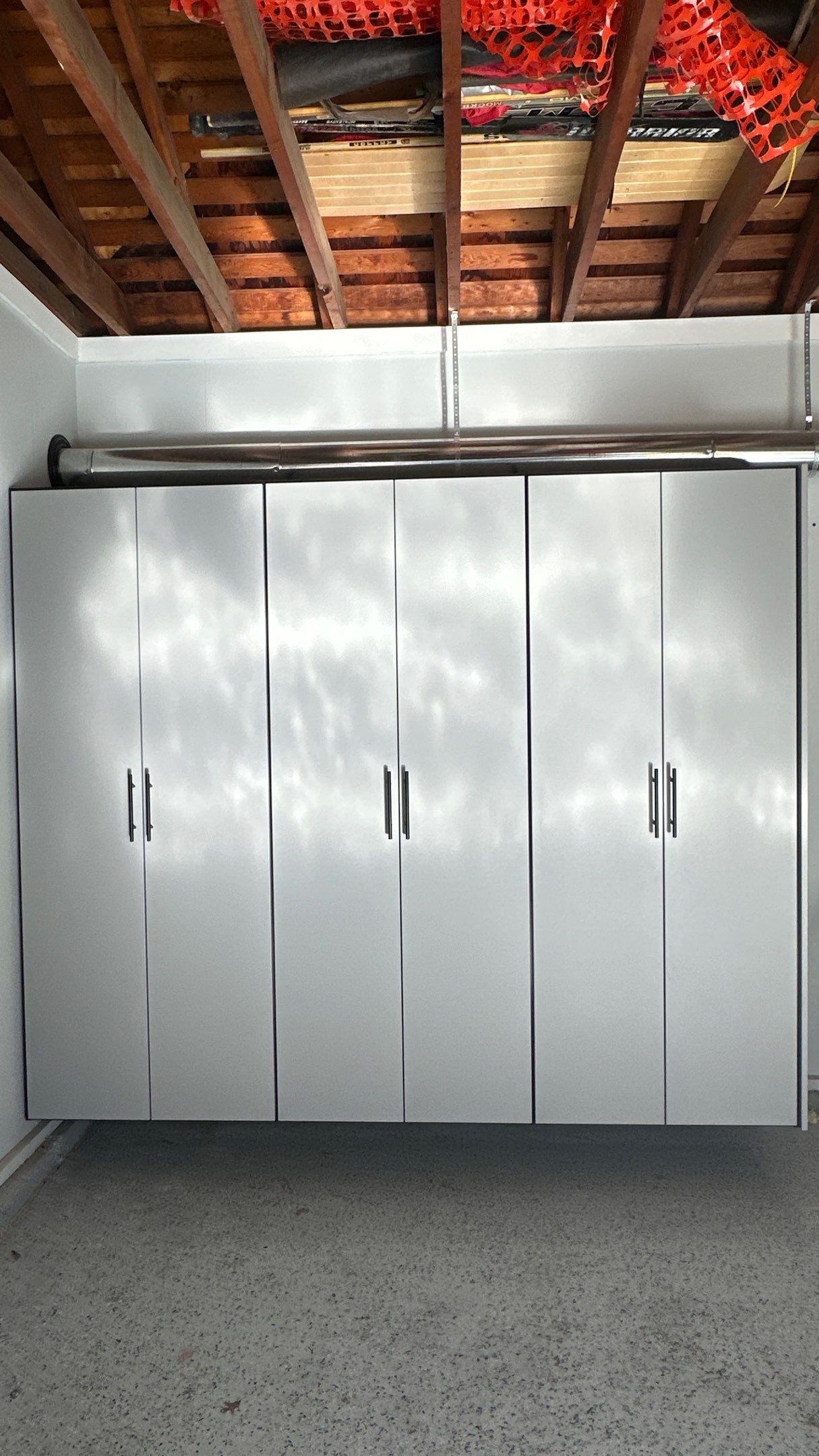 Jamie N added these beautiful cabinets for extra storage space by Banner Garage