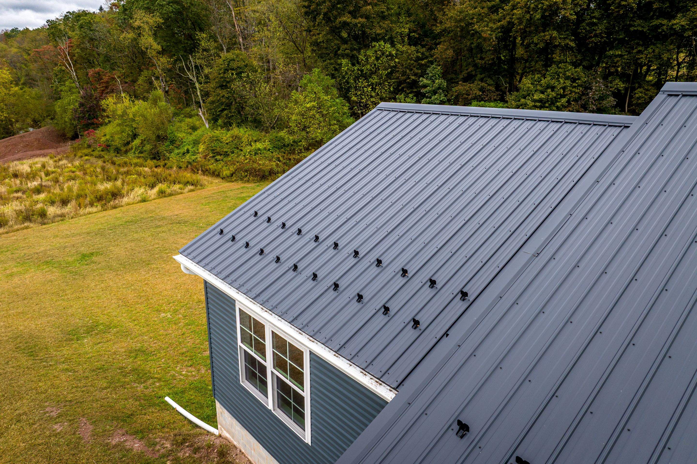 New Residential Addition with Blue Siding and Metal Roofing in Ashland by Esh Builders