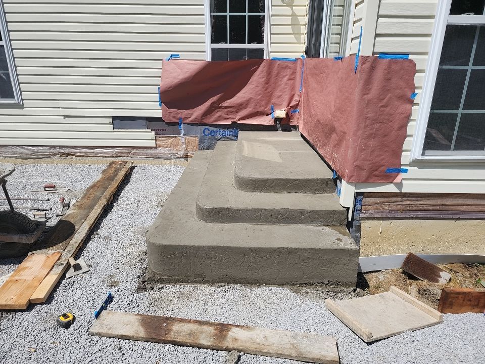Stamped Concrete, Entry Door, and Concrete  by Ivy Lea Construction