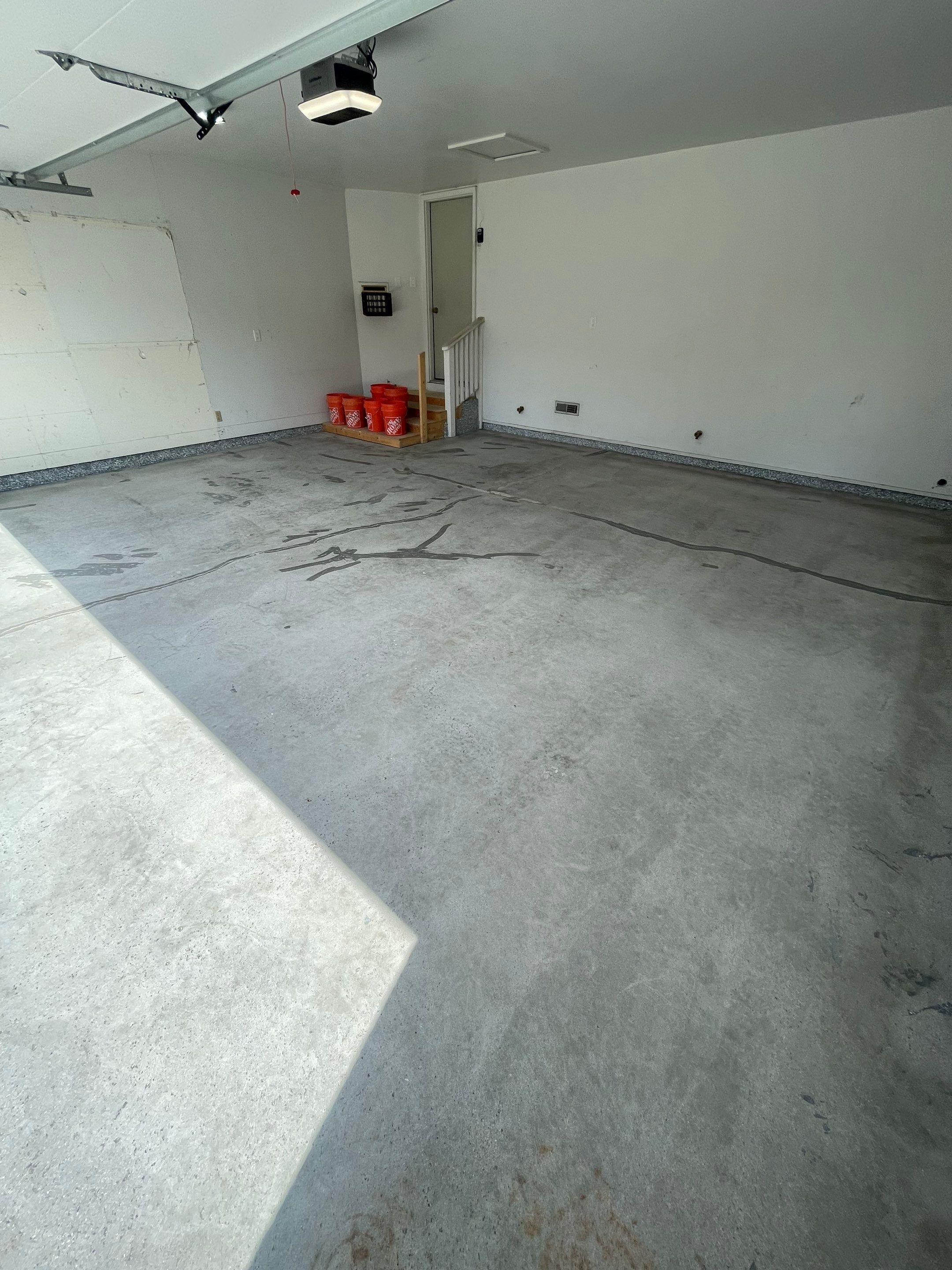 Grey Speckled Concrete Coating for Residential Garage in Yankton by Select Painting, Coatings & Garage Cabinets