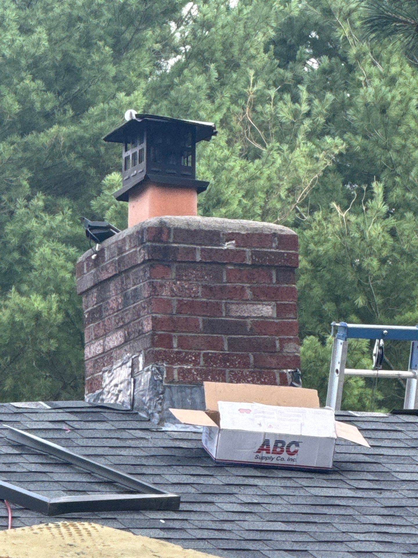Complete Roof Replacement with Chimney Flashing, Gutter Guard System, and Vinyl Siding Repairs by Mighty Dog Roofing of Greater Middlesex County