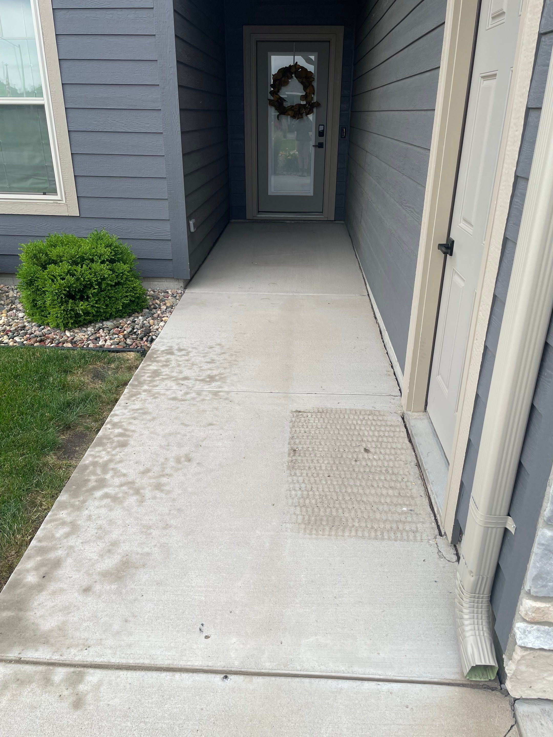 Textured Concrete Patio Coating and Custom Privacy Pergola in Sioux Falls by Select Painting, Coatings & Garage Cabinets