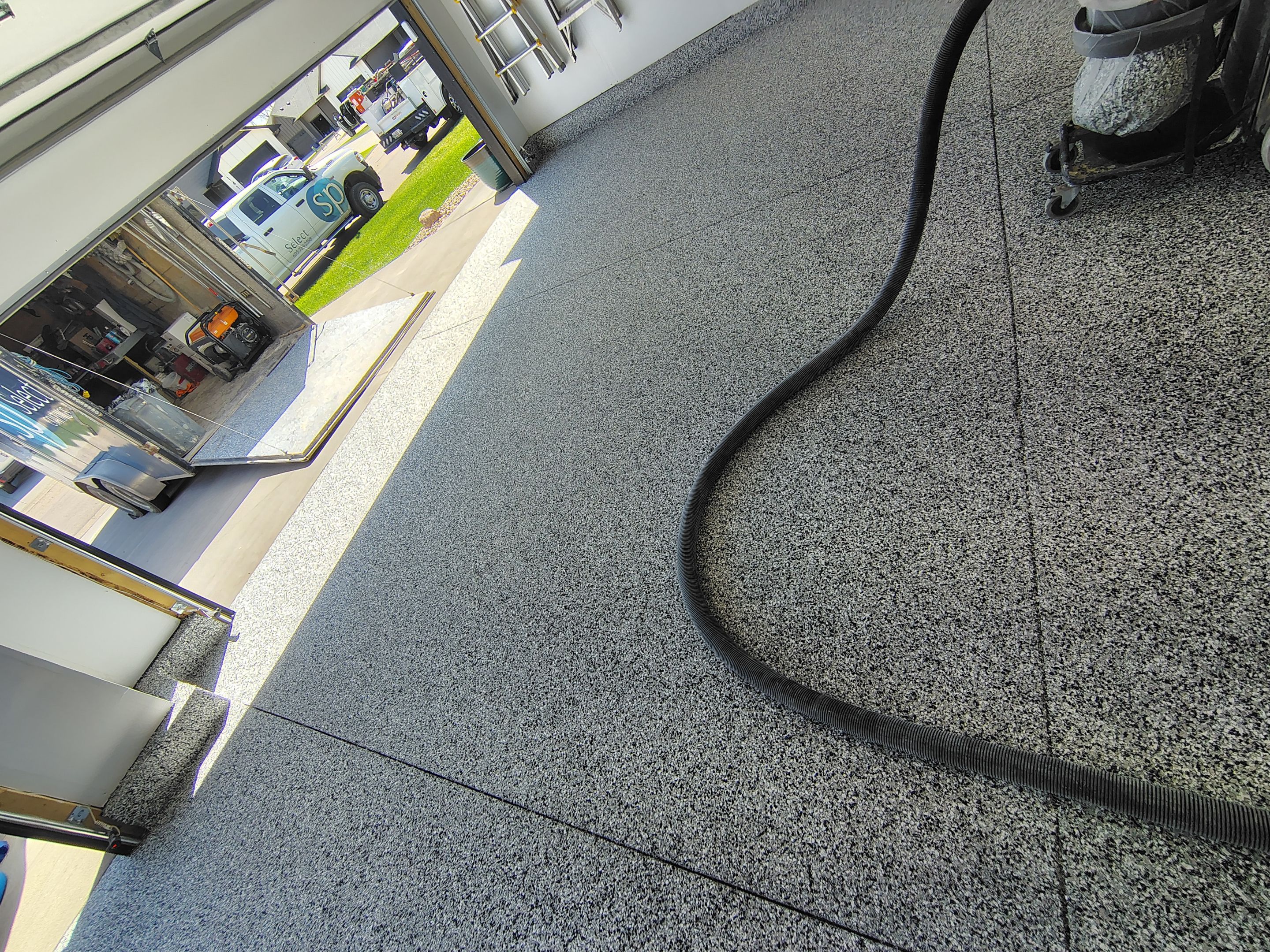 Decorative Flake Garage Floor Coating Installation in Tea, South Dakota by Select Painting, Coatings & Garage Cabinets