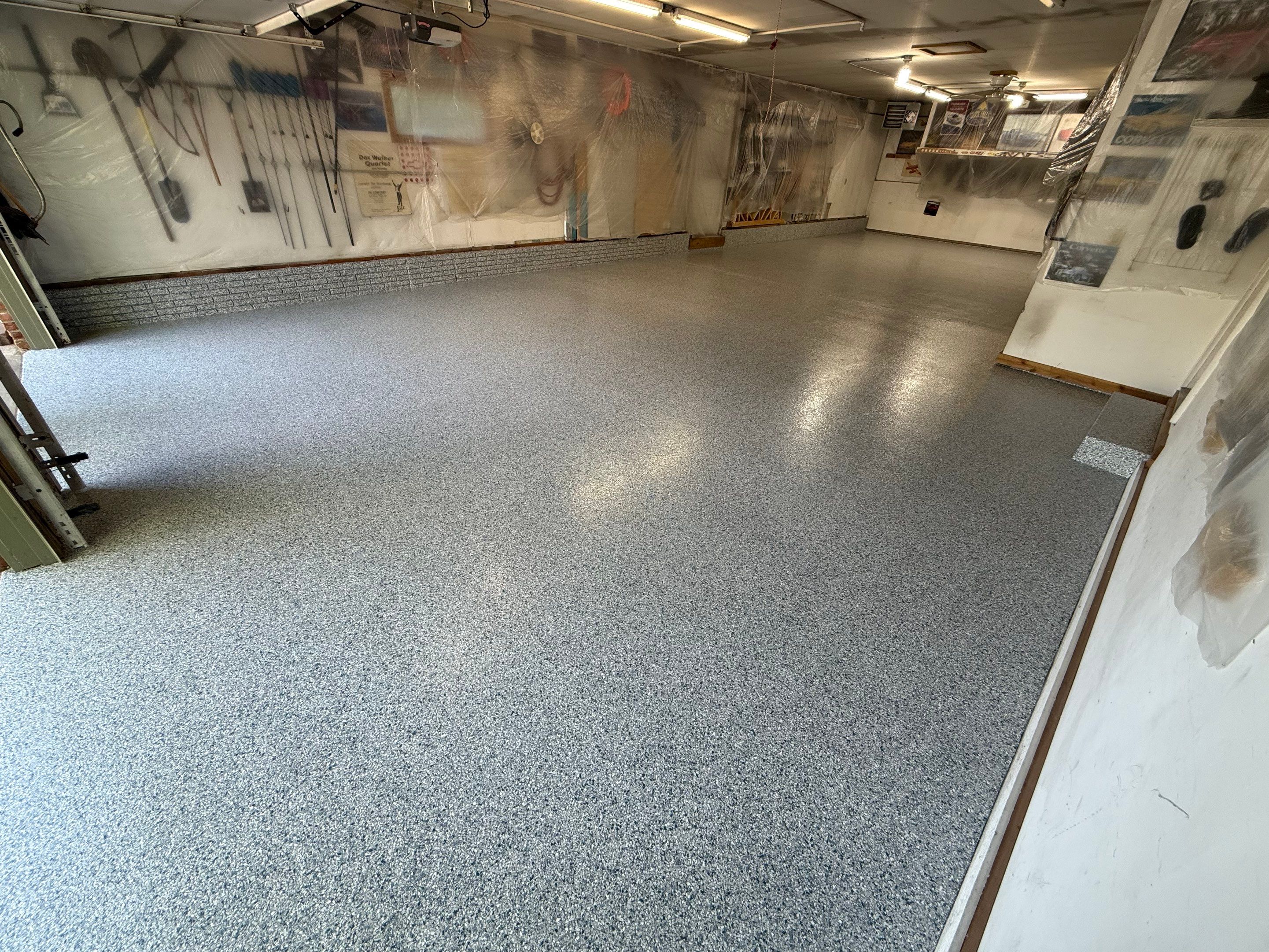 High-Performance Polyurea Garage Floor Coating and Stem Wall Finishing in Sioux Falls by Select Painting, Coatings & Garage Cabinets