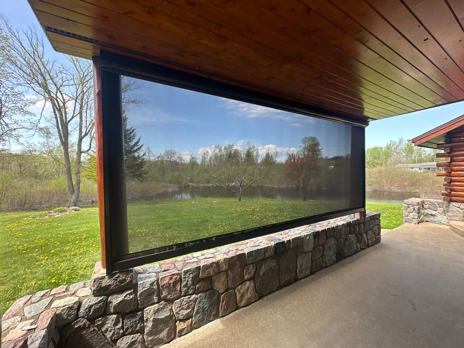 Sunesta Retractable Screen Installation on a Petoskey Log Home Porch by Rainbow Seamless Systems