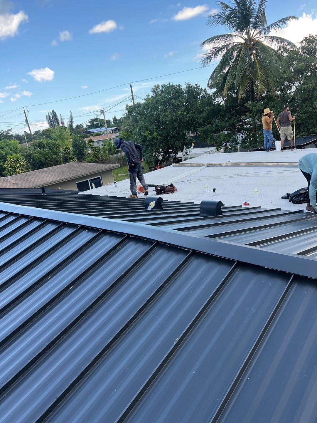 Standing Seam Metal & Flat Re-Roof using 1.5" Nail Strip 24ga Black Matte Kynar Coated Standing Seam Metal Panels by Morton Roofing, Inc.