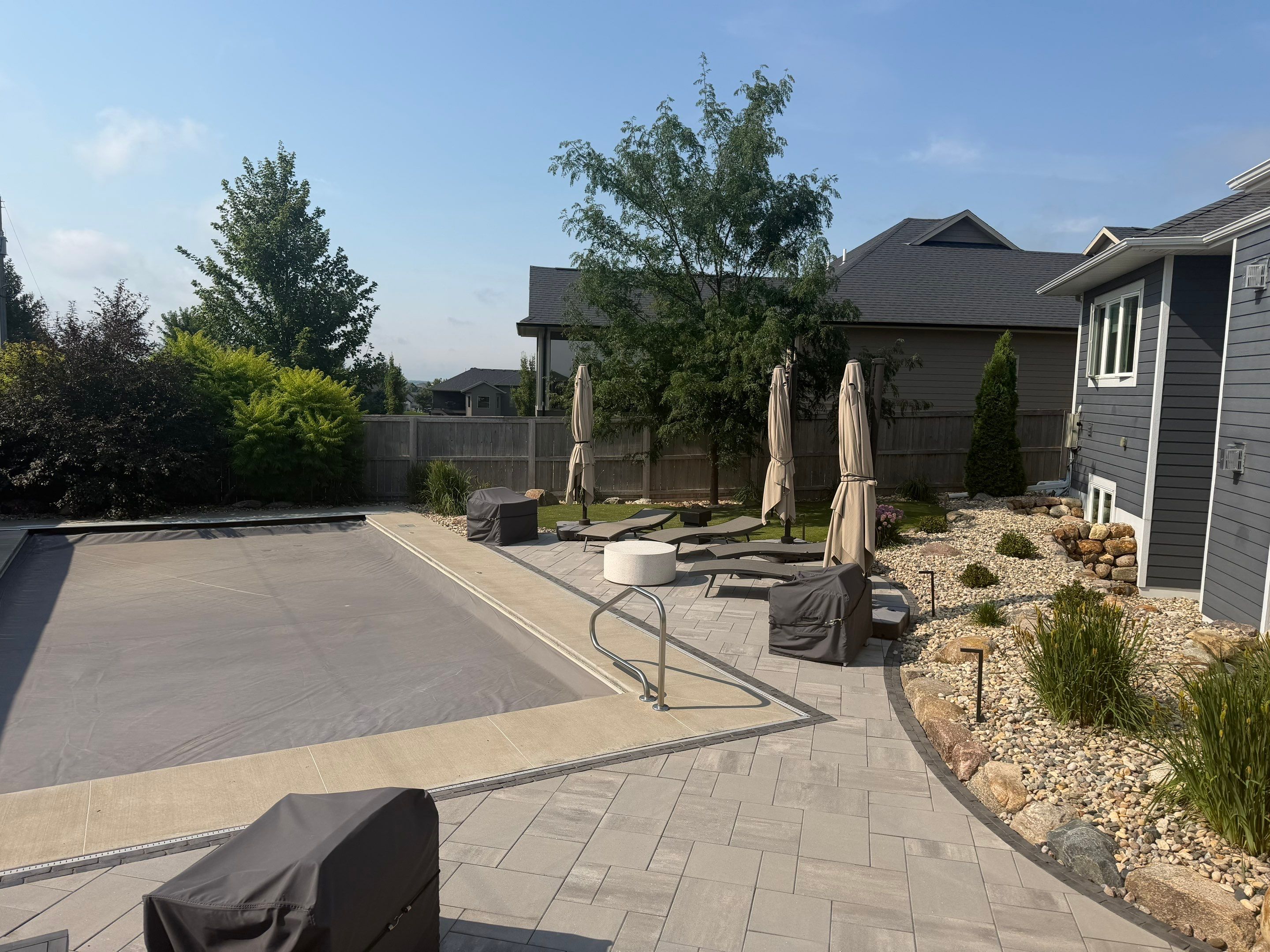 Custom Privacy Fence and Paver Patio Installation in Sioux Falls by Select Painting, Coatings & Garage Cabinets
