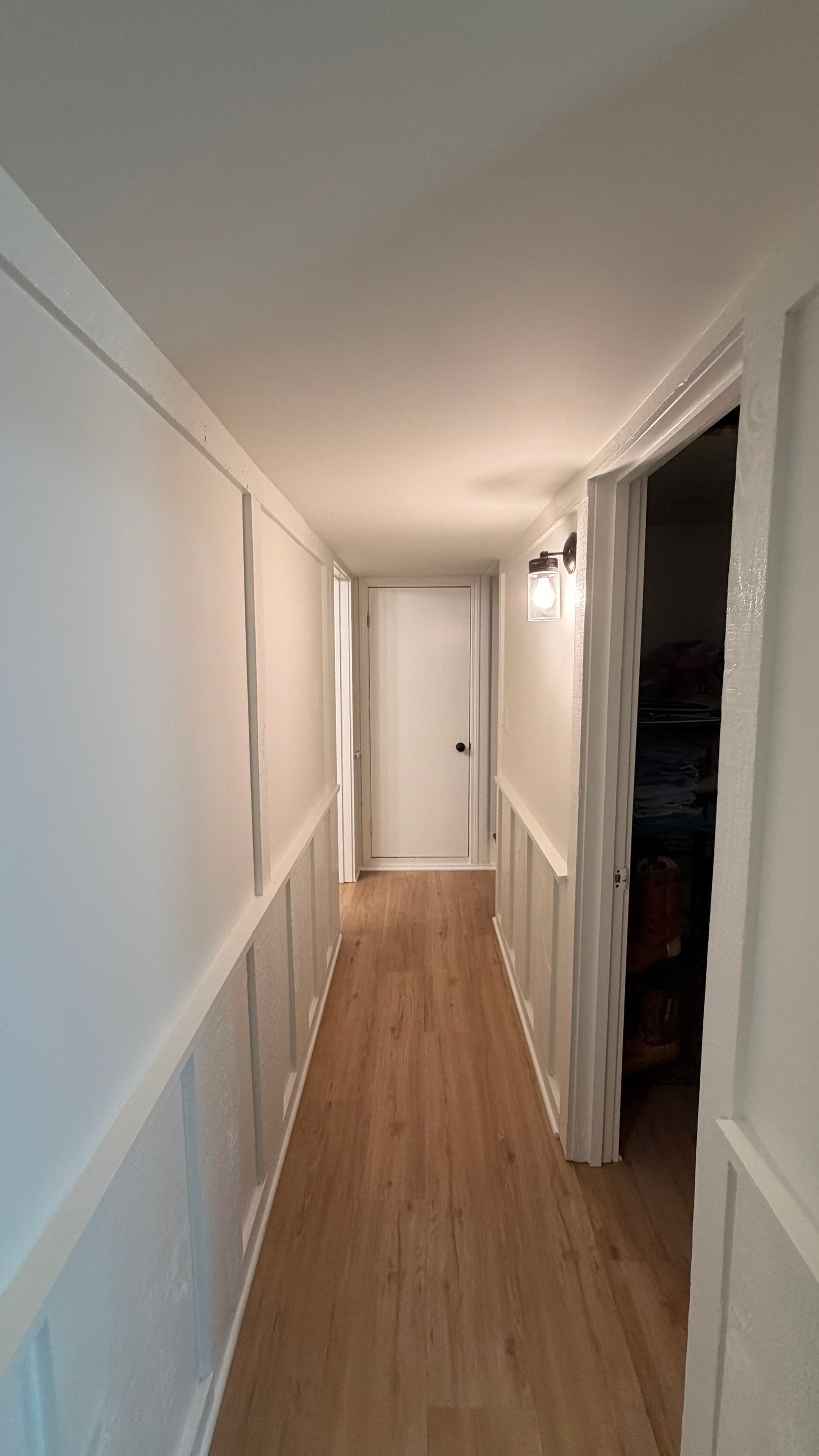 Basement Remodeling with Wood-Look Flooring and Custom Wainscoting in Dunwoody by Swift Home Renovations