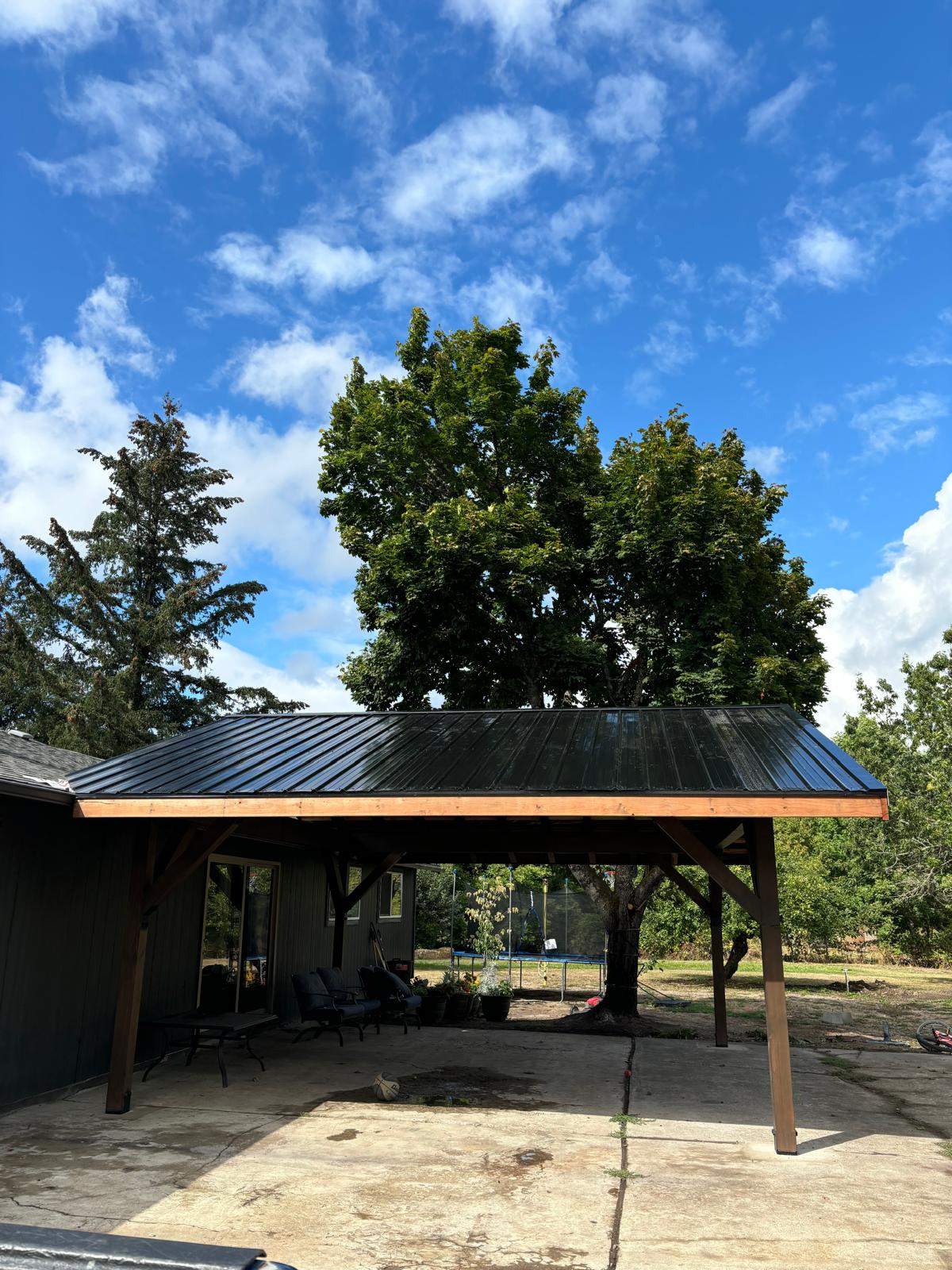 Custom Timber Frame Patio Cover with Black Metal Roof by American Made Construction