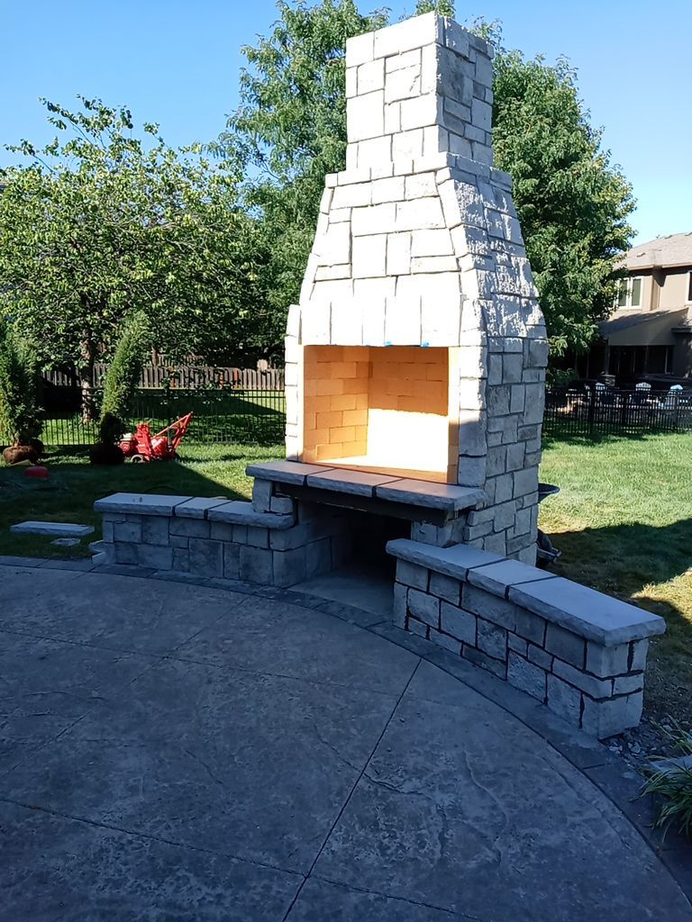 Back Yard Fireplace and Landscape by LAND ESCAPES LLC