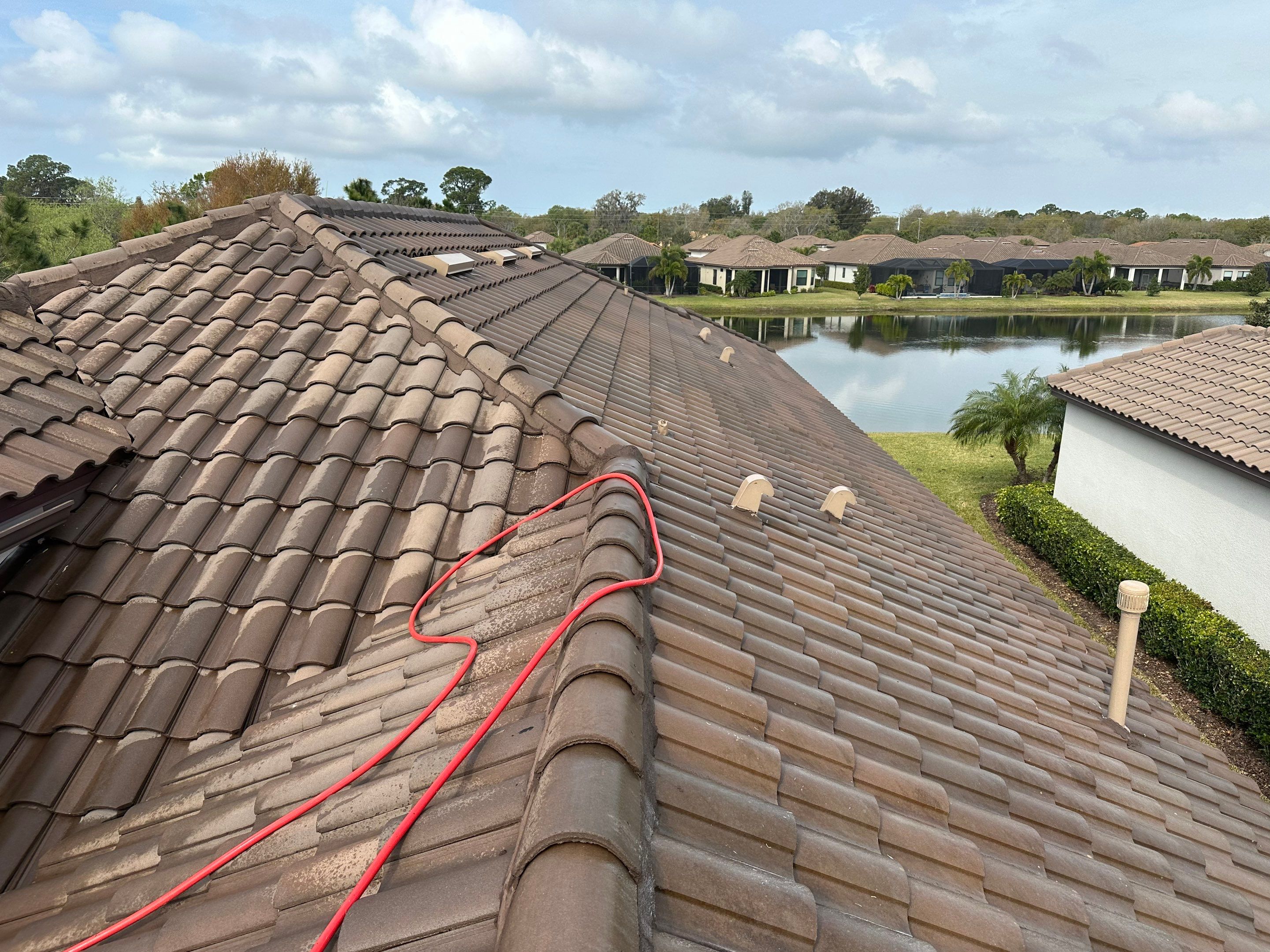 Concrete Tile Roof, Paver Pool Deck, Screen Enclosure & Driveway Cleaning in Artisan Lakes Esplanade, Palmetto, FL | Sunshine AquaWash by Sunshine AquaWash