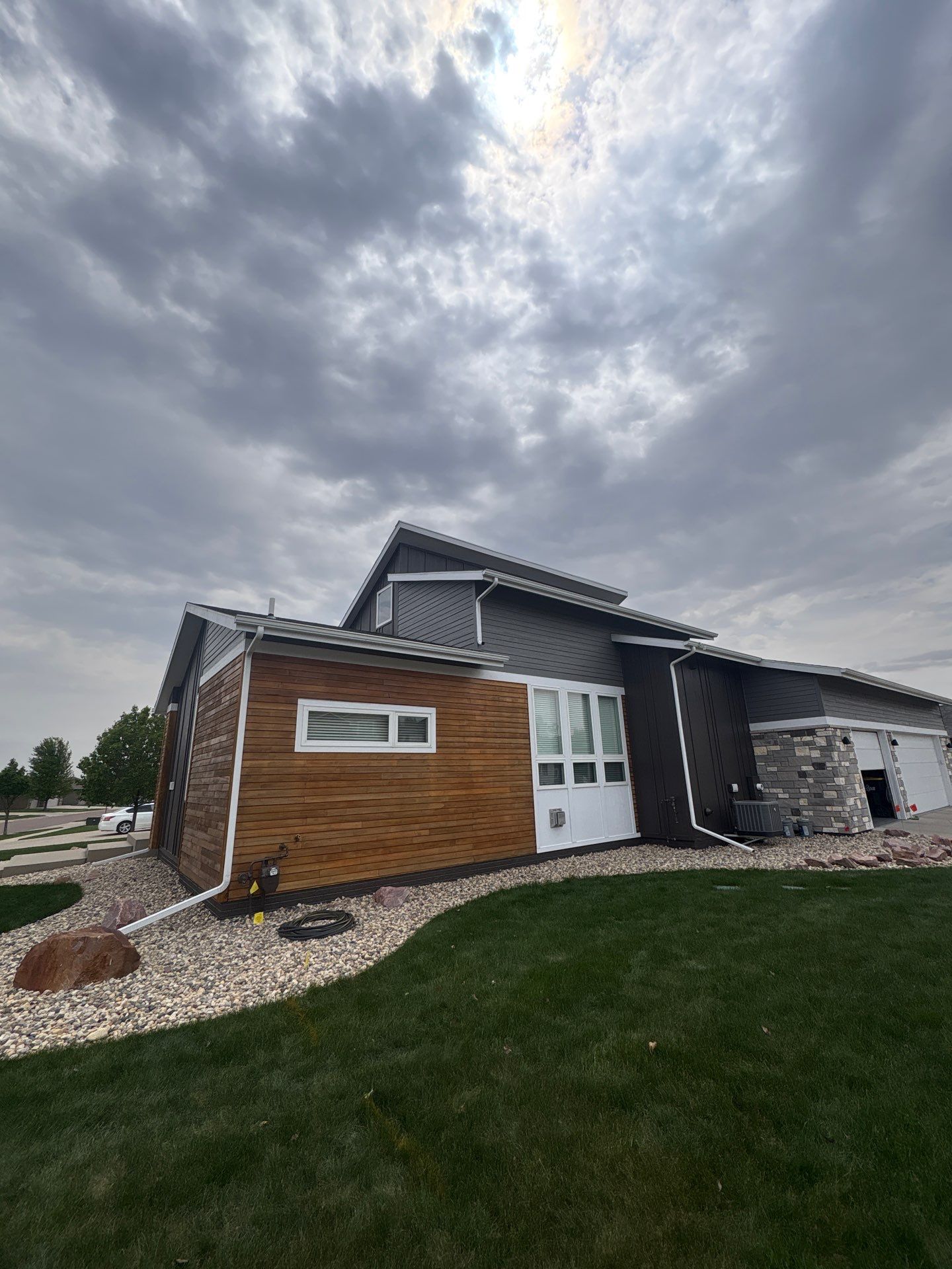 Modern Exterior Transformation Featuring Dark Board and Batten Siding in Sioux Falls by Select Painting, Coatings & Garage Cabinets