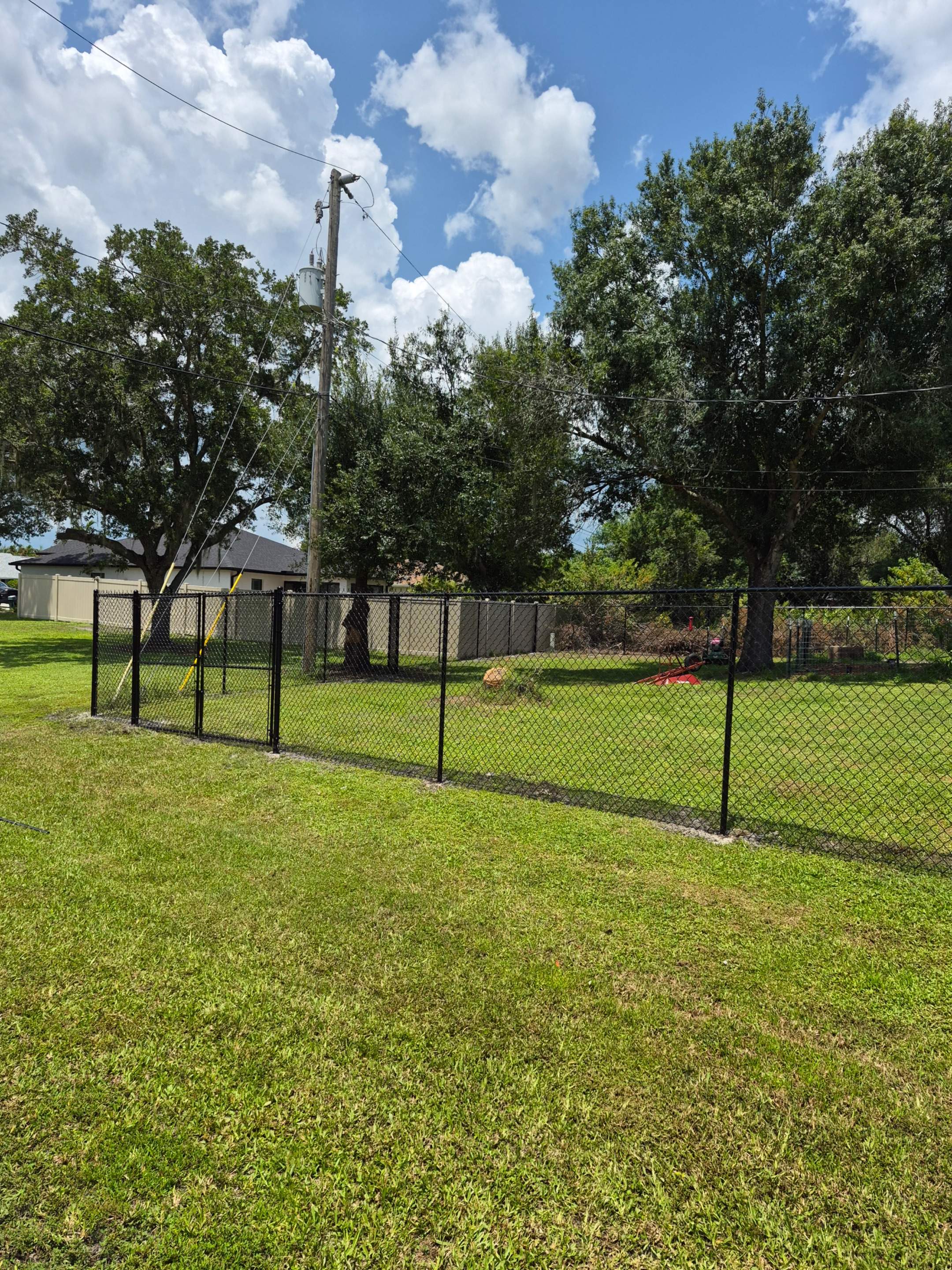 Black Chain Link Perimeter Fencing with Double Gates in Port Charlotte by True Fence LLC