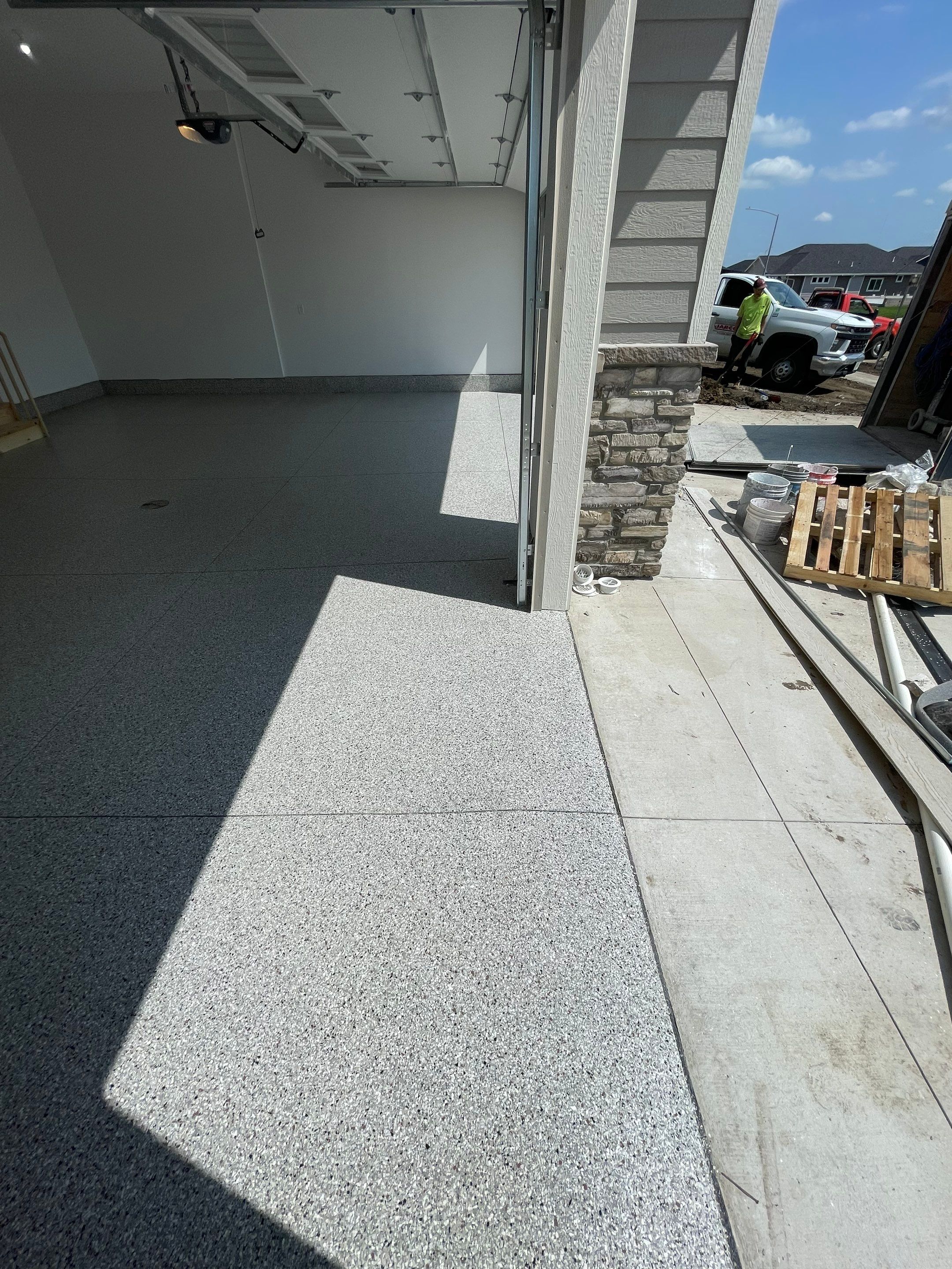 Grey Speckled Garage Floor Coating in Sioux Falls by Select Painting, Coatings & Garage Cabinets