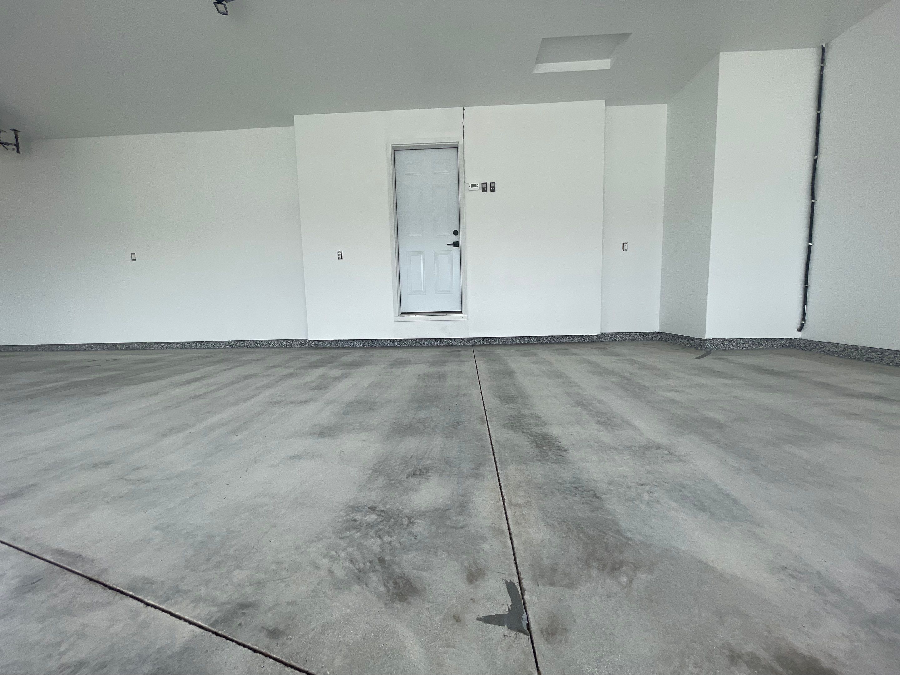 Grey Flake Epoxy Garage Floor Coating in Sioux Falls by Select Painting, Coatings & Garage Cabinets
