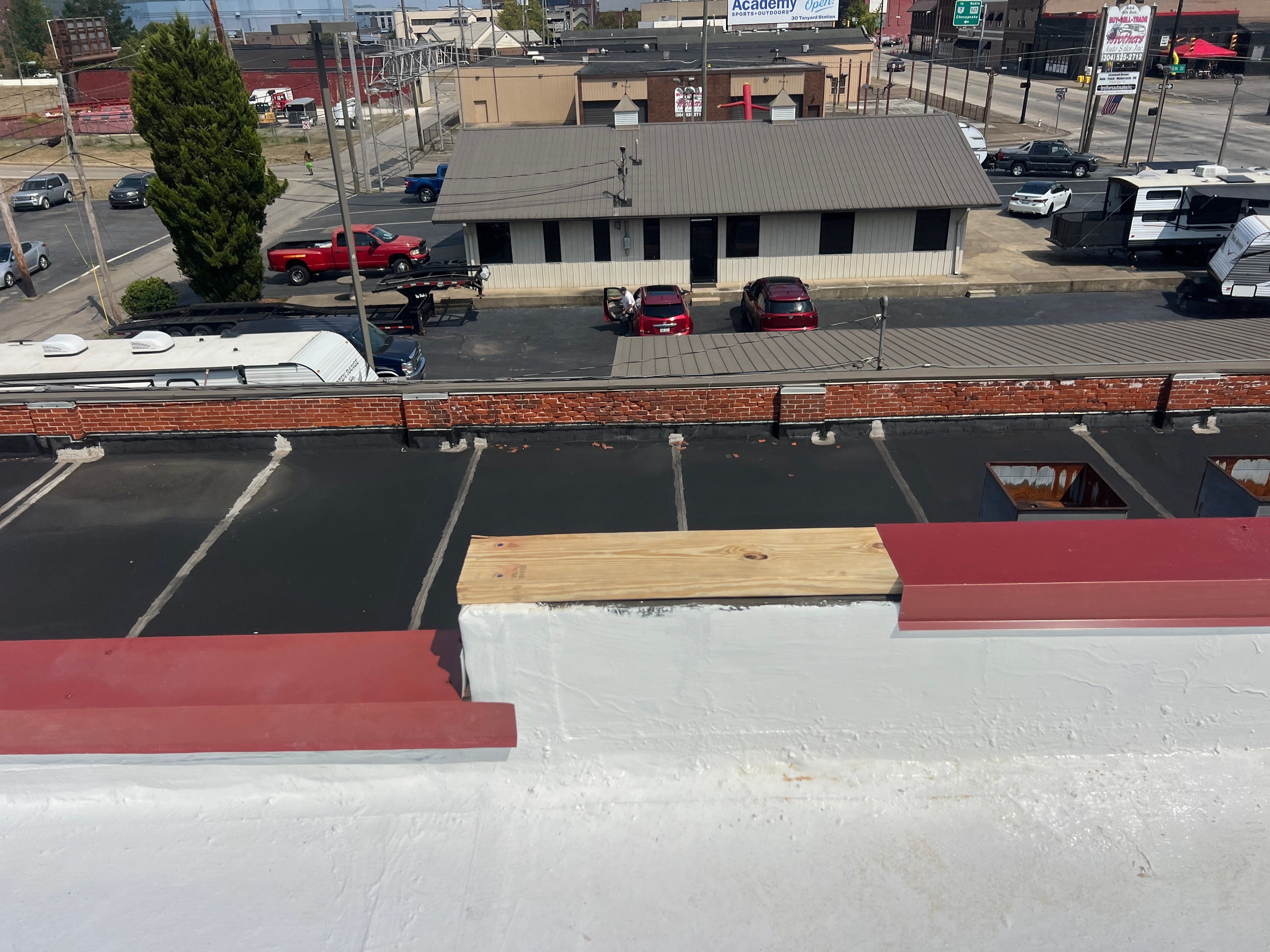 Commercial Roofing Installation using smartcoat Roof coating by Fahey Roofing + Contracting