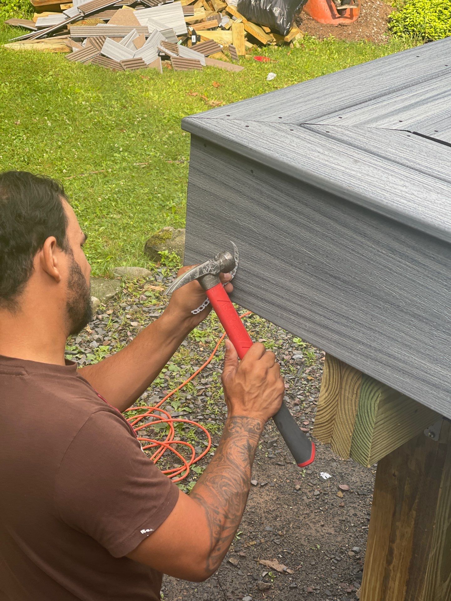 Raised Gray Composite Deck and Staircase Construction in Pocono Summit, PA by Herts Roofing & Construction