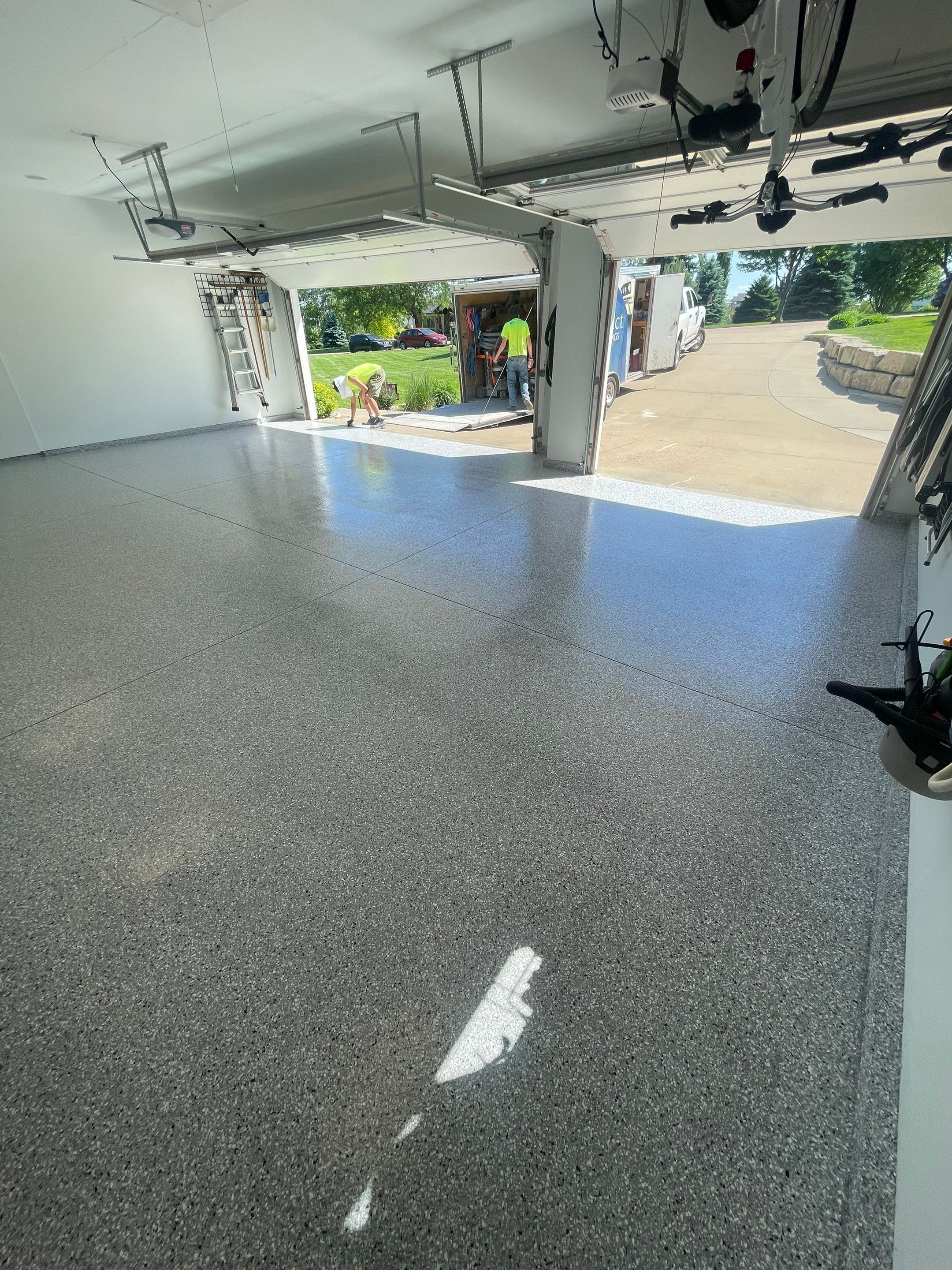 Feather Grey Garage Floor Coating Installation in Sioux Falls by Select Painting, Coatings & Garage Cabinets