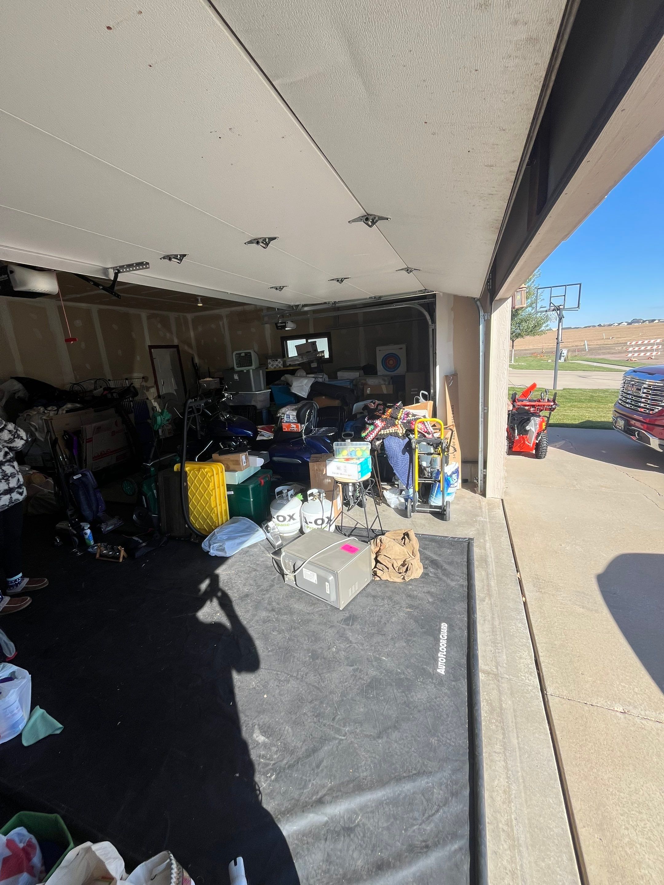 Multi-Car Garage Concrete Coating and Epoxy Finish in Sioux Falls by Select Painting, Coatings & Garage Cabinets