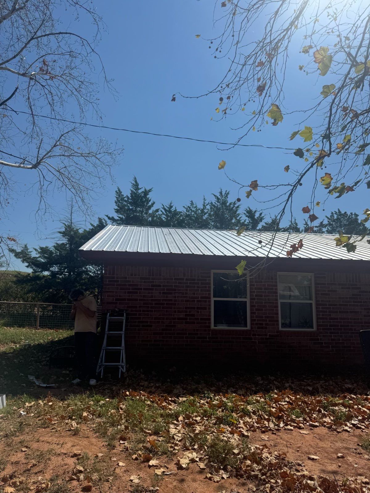 Corrugated Metal Roof Repair for Brick Home in Lindsay by BANA Roofing and Solar Supply