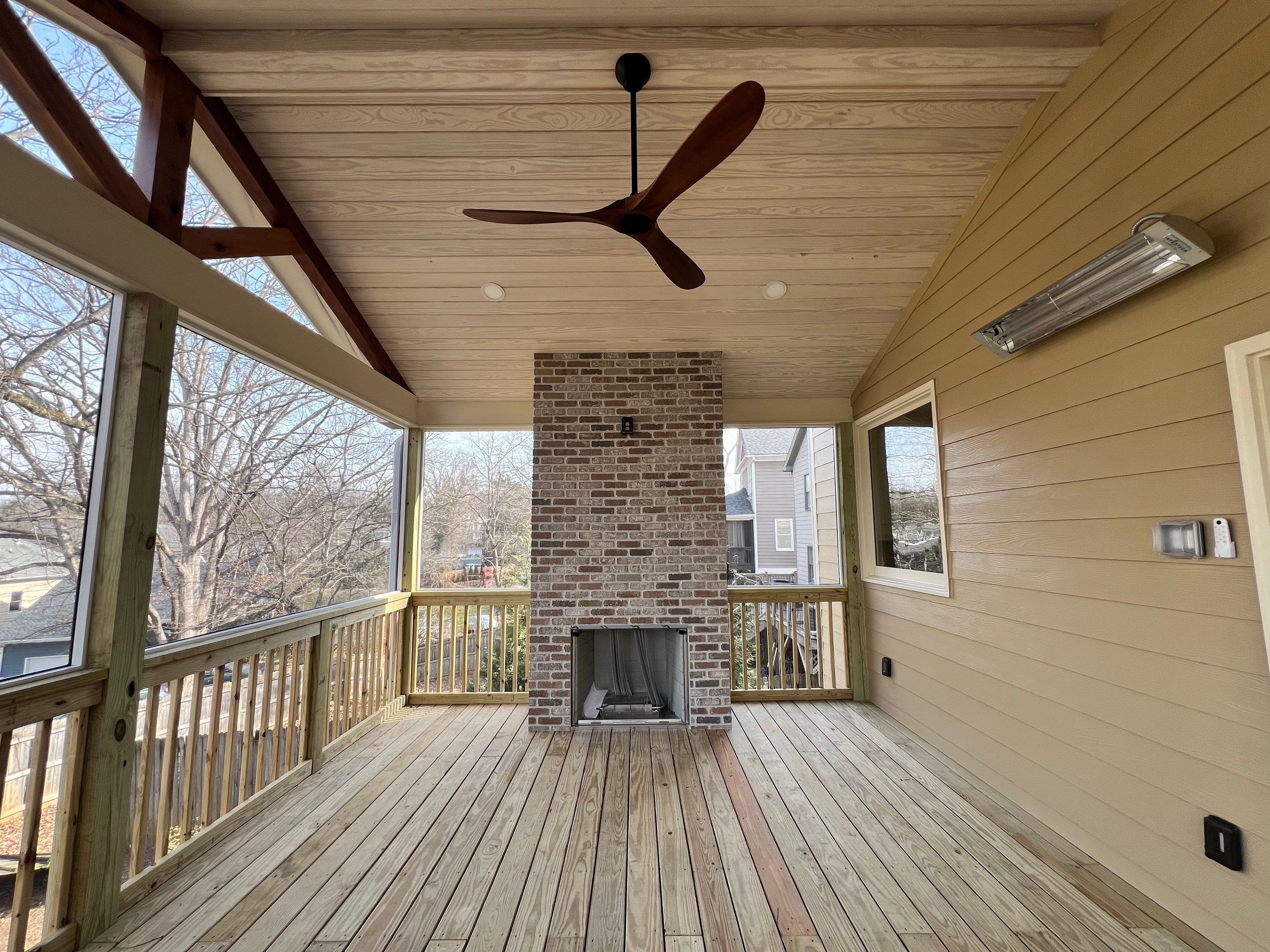 Screened-In Porch With Fireplace by Swift Home Renovations