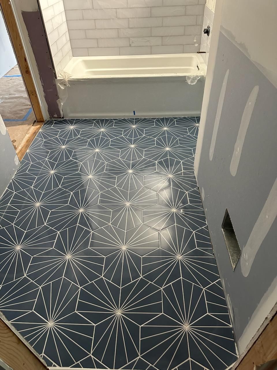 Jack & Jill Bathroom Floor + Dog Washing Nook with Niche using Porceline Subway Tile by Footprints Floors Morristown