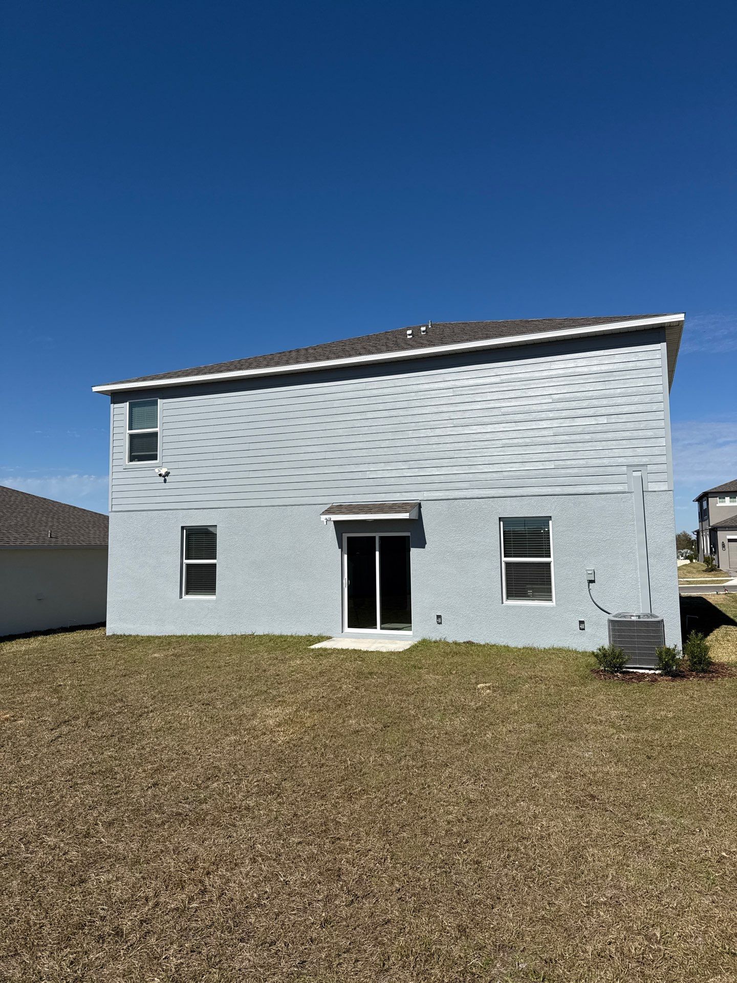 White Down Spouts and Seamless Gutters using downspouts in Dade City FL by Gutter Professors