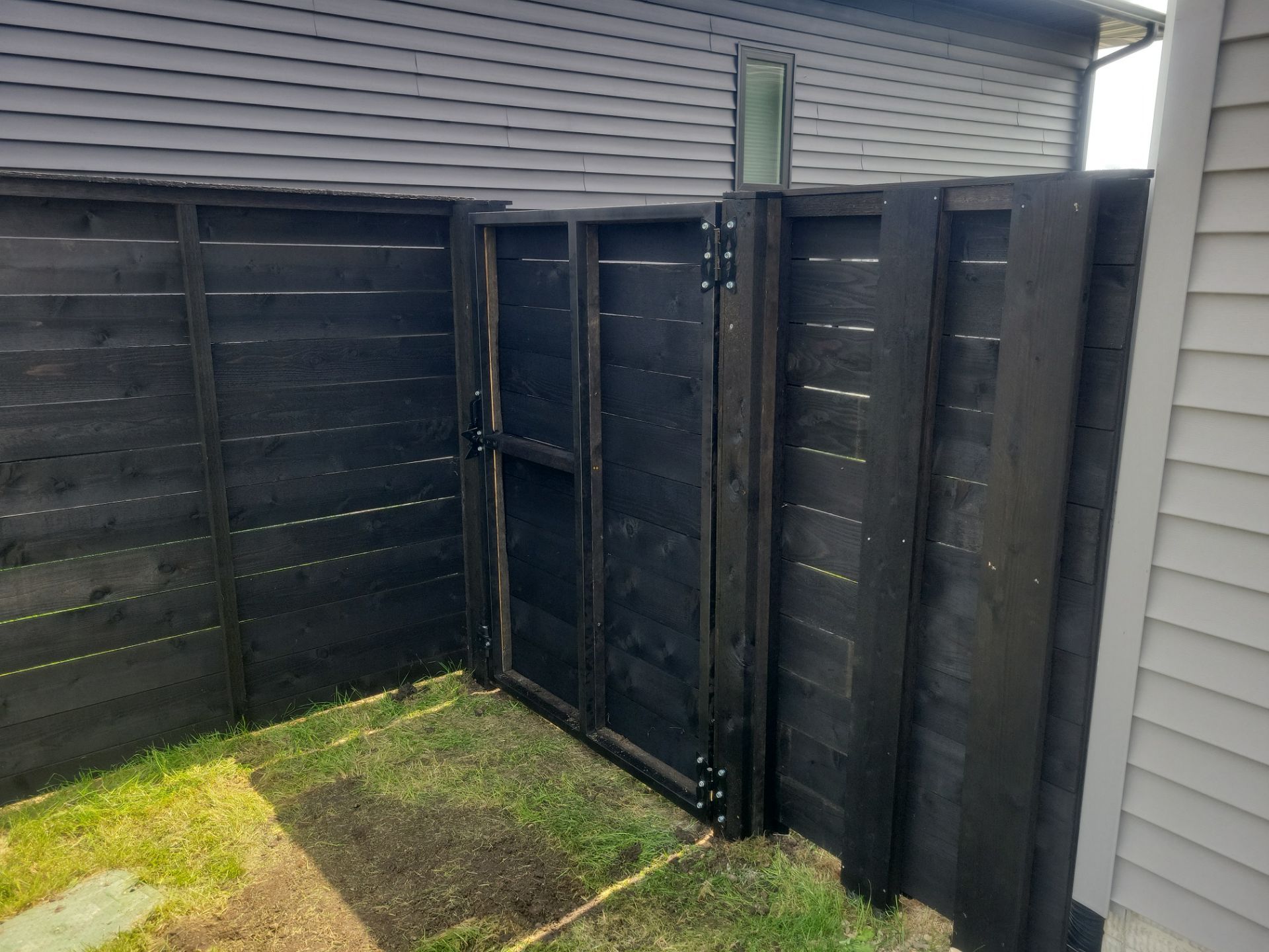 Modern Black Stained Horizontal Privacy Fence Installation in Cedar by Perfect Picket Fence and Stain