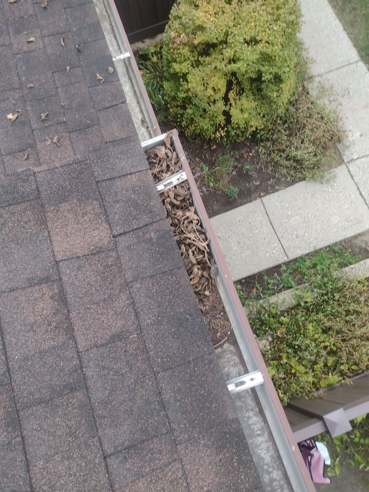 Commercial gutter cleaning Battle Creek, MI before photo with filled gutters