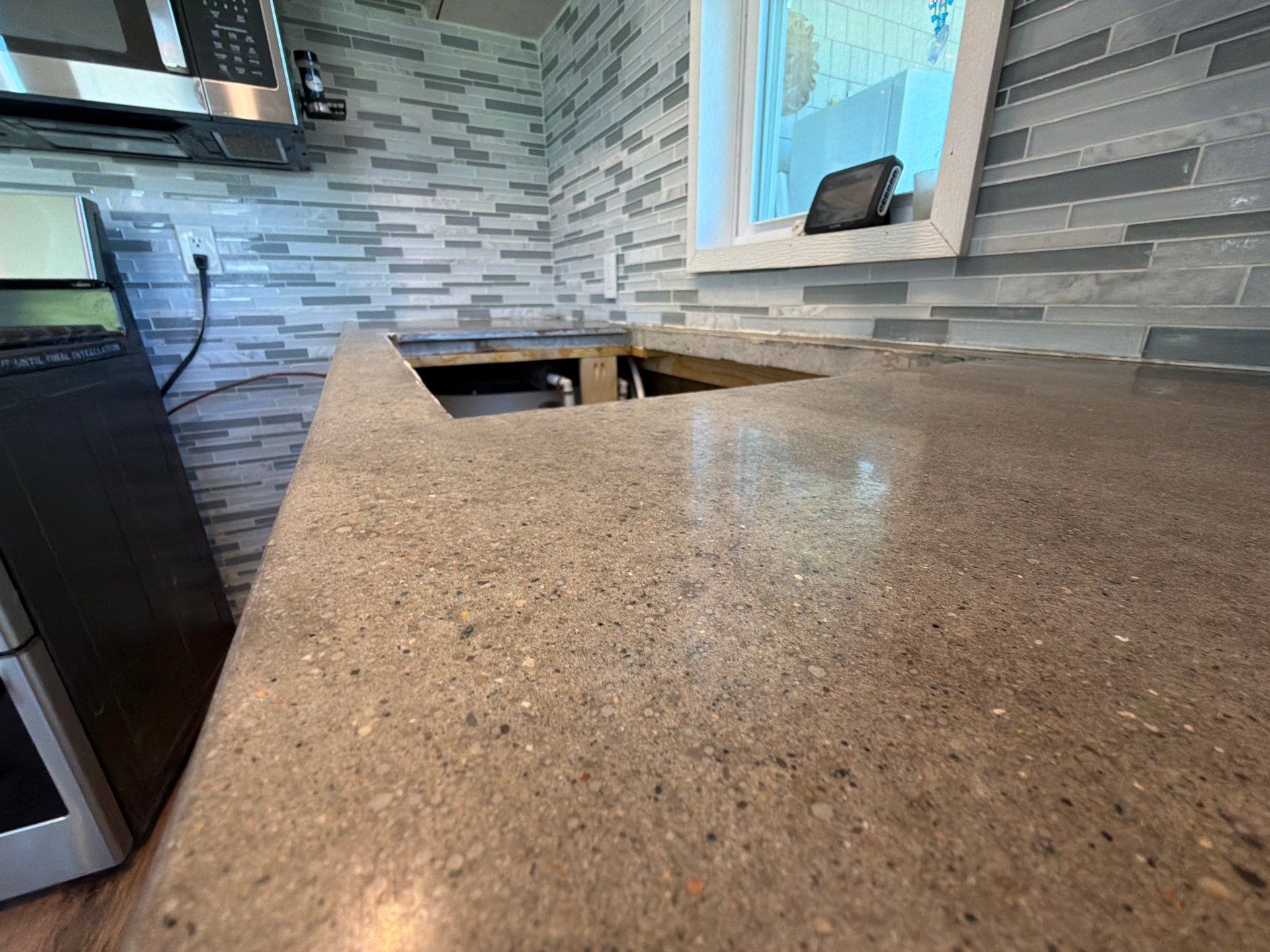 Custom Metallic Epoxy Floor and Polished Countertop Installation in Mears by Gordon Painting