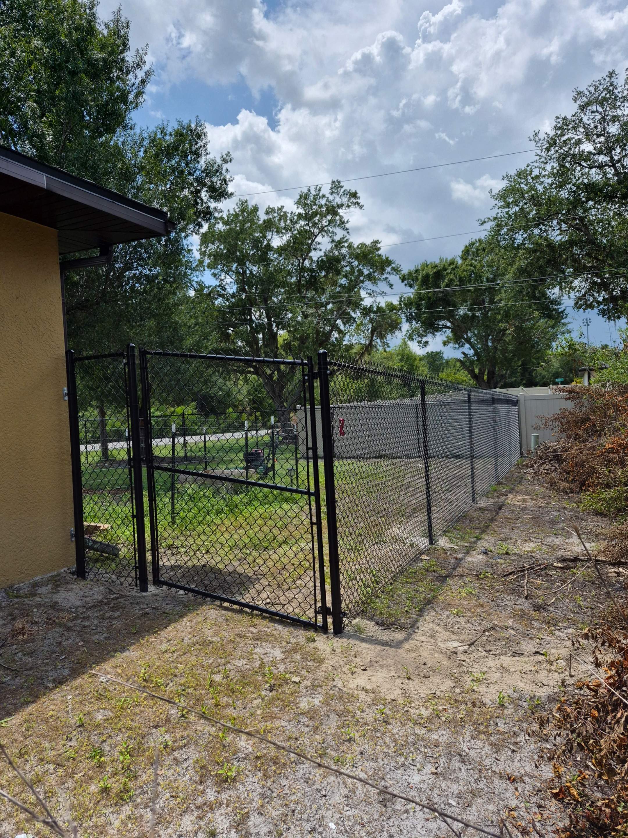 Black Chain Link Perimeter Fencing with Double Gates in Port Charlotte by True Fence LLC