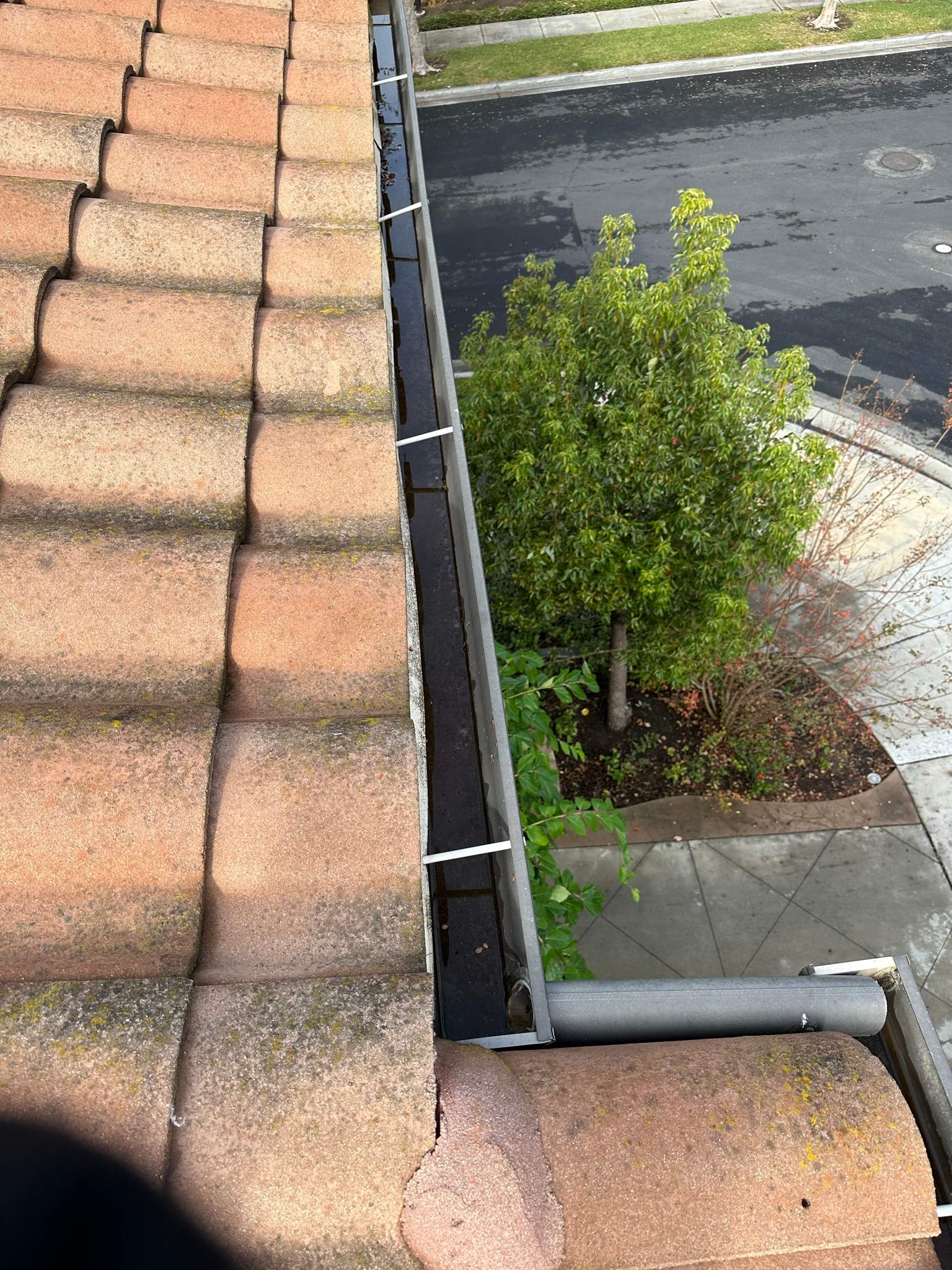 Clogged gutters at this Irvine home in Woodbury by Property Cleaning Experts, LLC