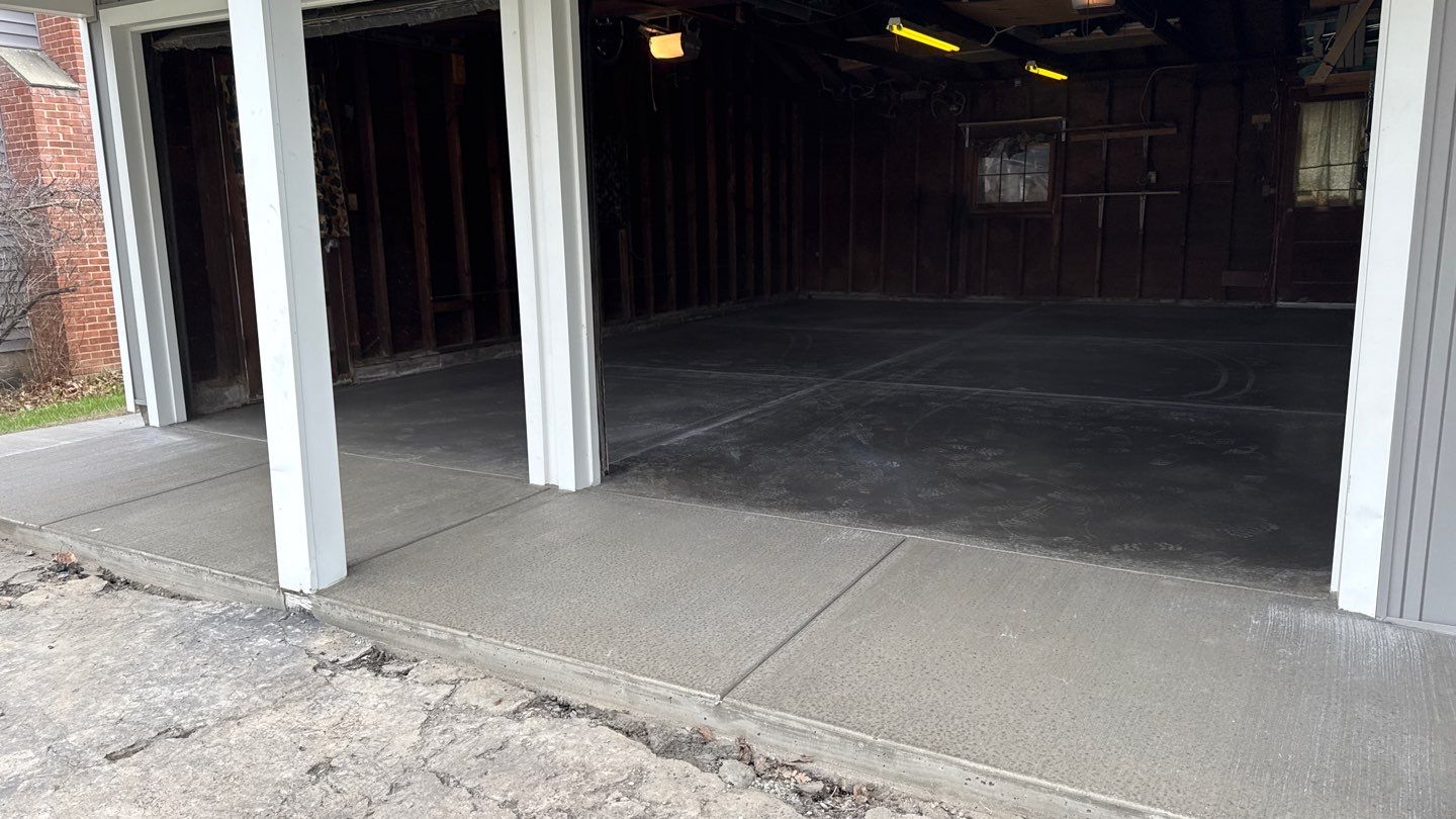 Concrete garage floor replacement with a broom finished apron and sidewalk by NG Masonry & Construction LLC