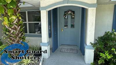 Impact Rated Colonial Shutters in Pigeon Blue