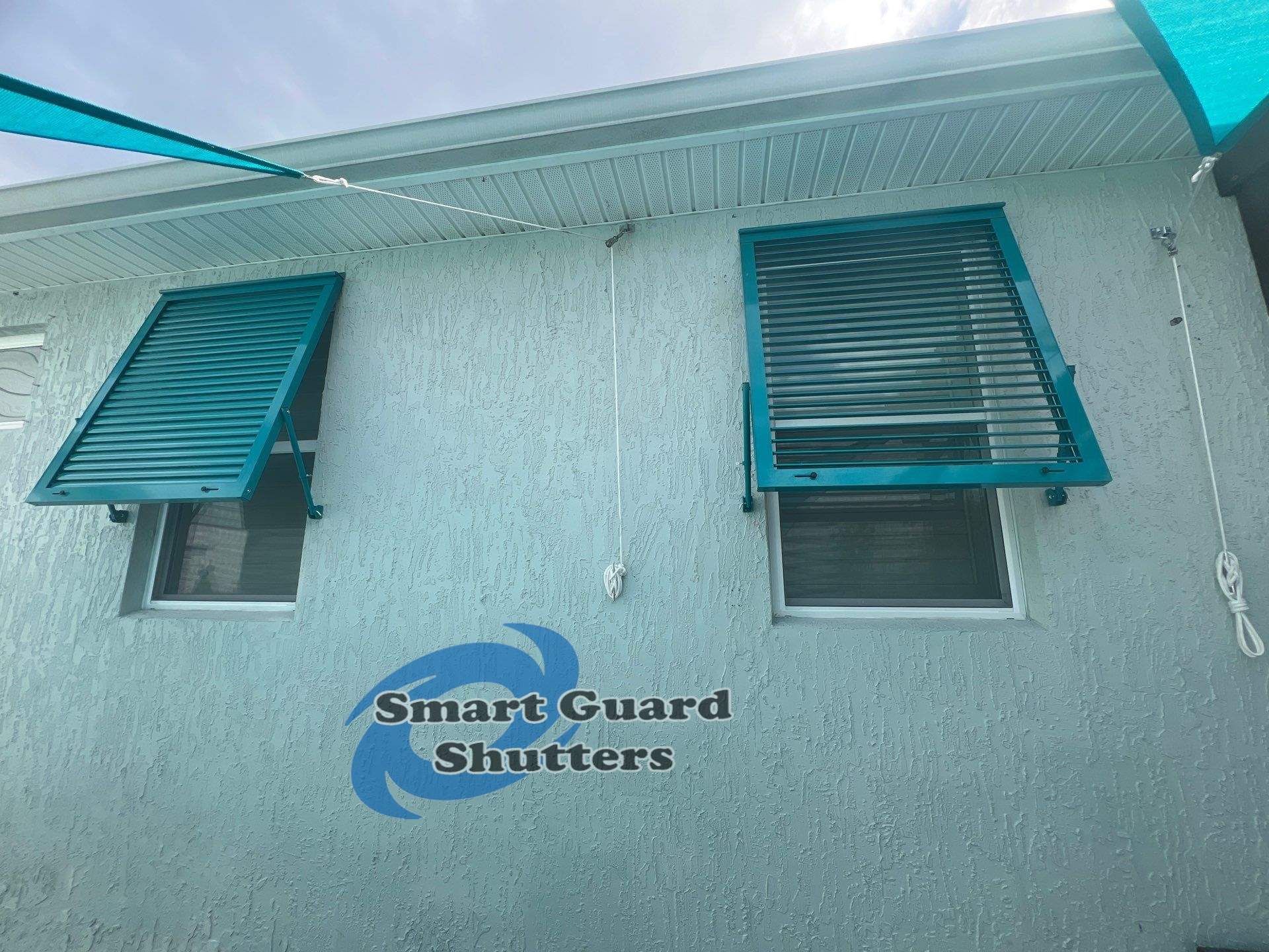 Impact Bahama Shutters in Water Blue by Smart Guard Shutters