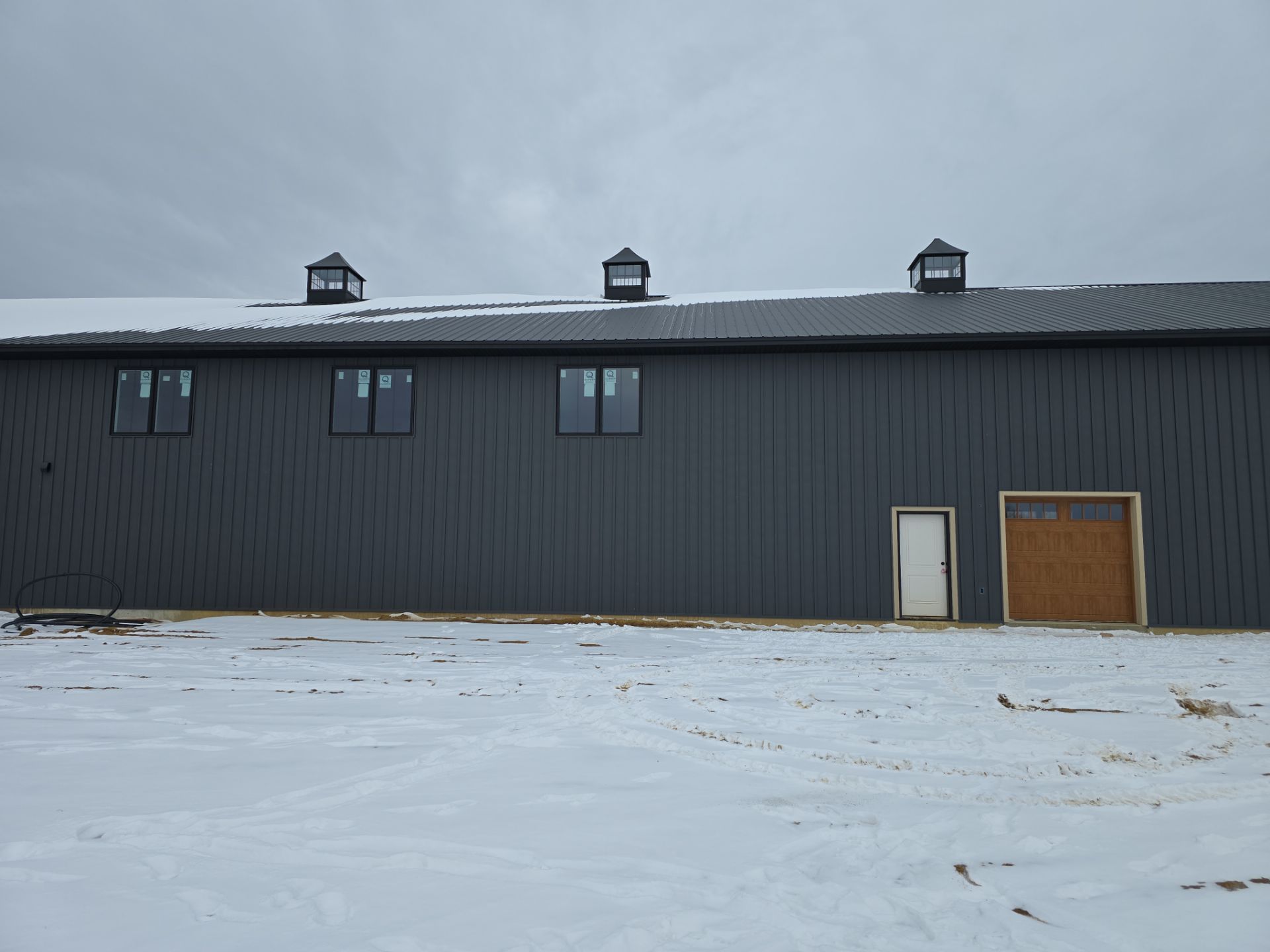 New Home construction w/ board and batten sides and metal roof  by Miles Construction 