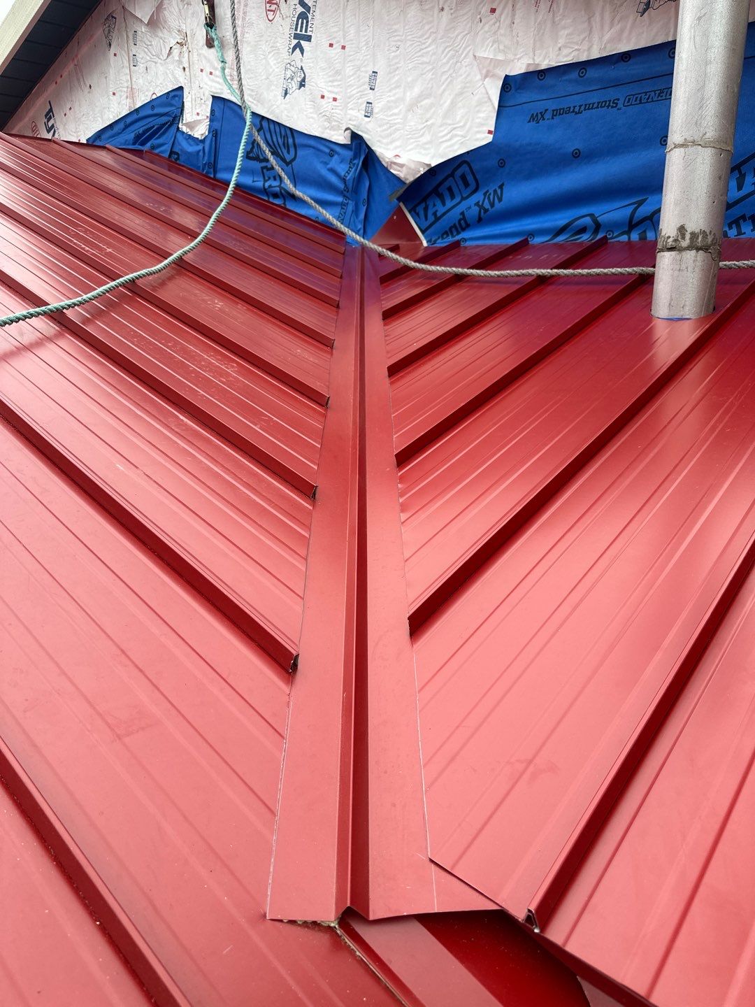 Commercial Roofing Installation using 12" Prolok metal by Top Notch Roofing Inc